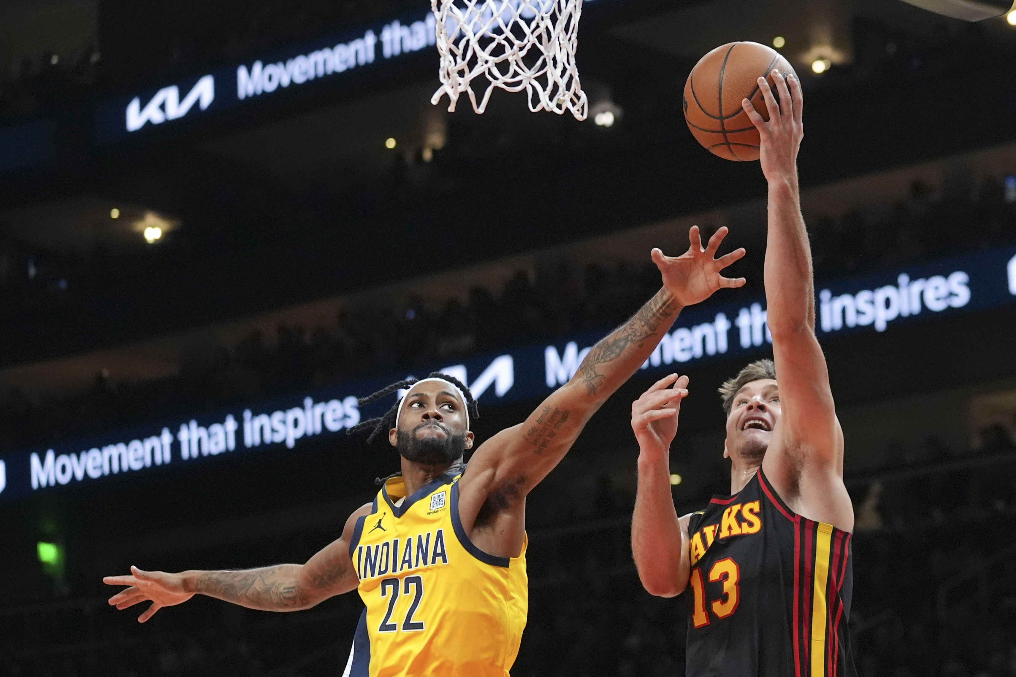 Atlanta Hawks guard Bogdan Bogdanovic (13) shoots as Indiana Pacers forward Isaiah Jackson (22) defends during the first half of an NBA basketball game Friday, Jan. 12, 2024, in Atlanta. (AP Photo/John Bazemore)