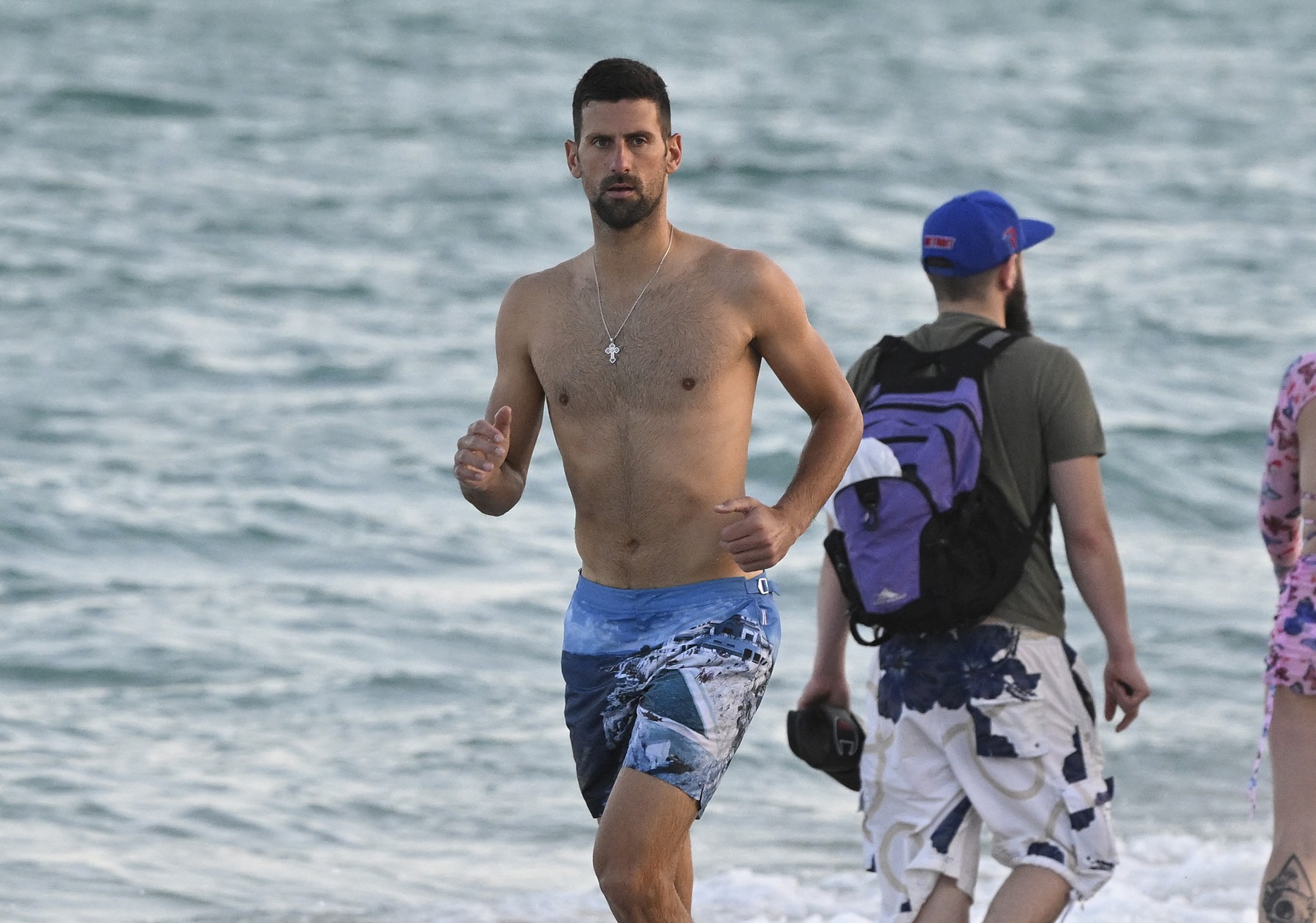EXCLUSIVE: Novak Djokovic is seen swimming and running on Miami Beach after withdrawing from the Miami Open following his shock defeat at Indian Wells.
