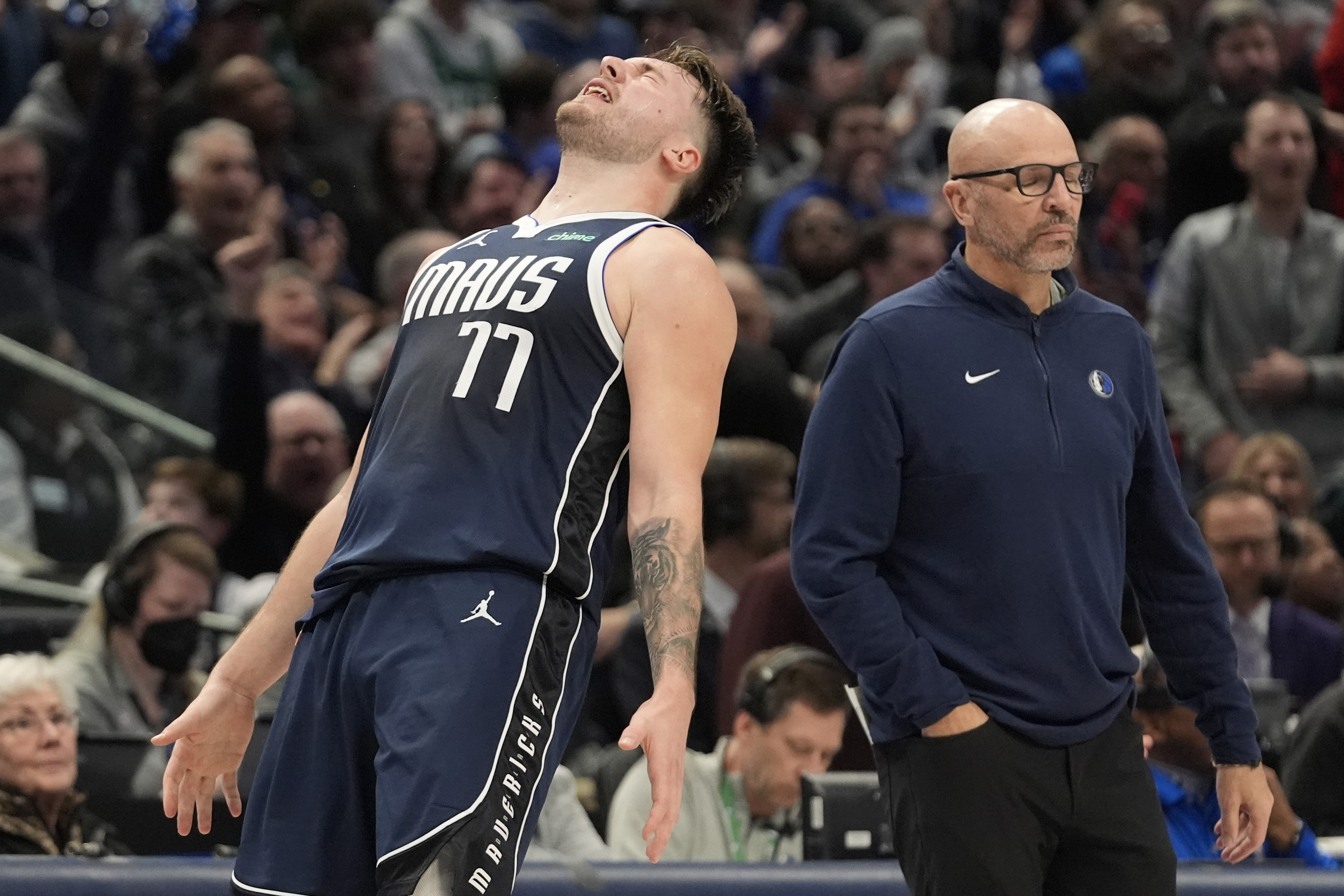 Dallas Mavericks guard Luka Doncic (77) reacts to a play in front of head coach Jason Kidd during the second half of an NBA basketball game against the Boston Celtics in Dallas, Monday, Jan. 22, 2024. (AP Photo/LM Otero)