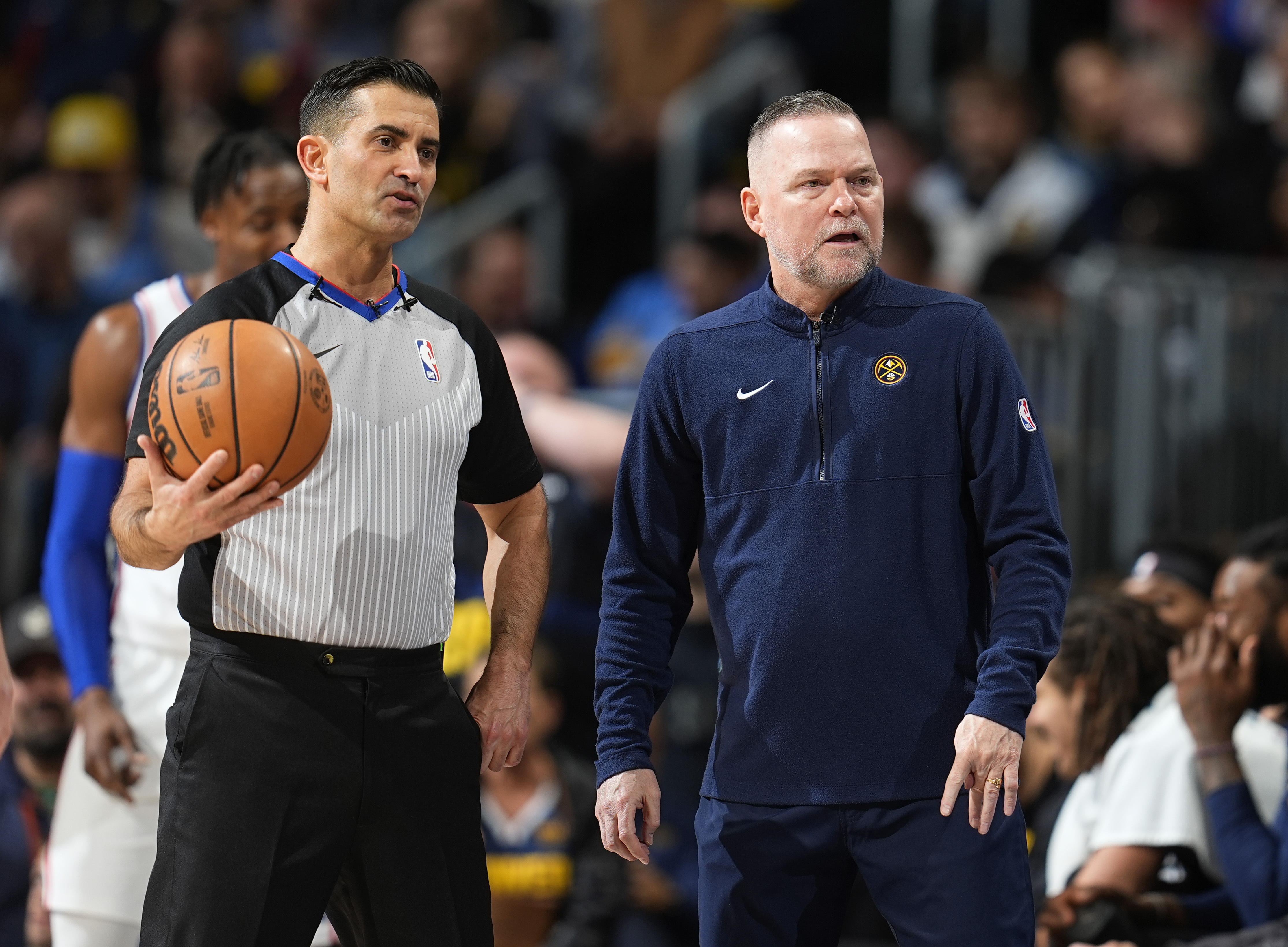 Denver Nuggets head coach Michael Malone, right, argues a call with referee Zach Zarba in the second half of an NBA basketball game against the Philadelphia 76ers, Saturday, Jan. 27, 2024, in Denver. (AP Photo/David Zalubowski)