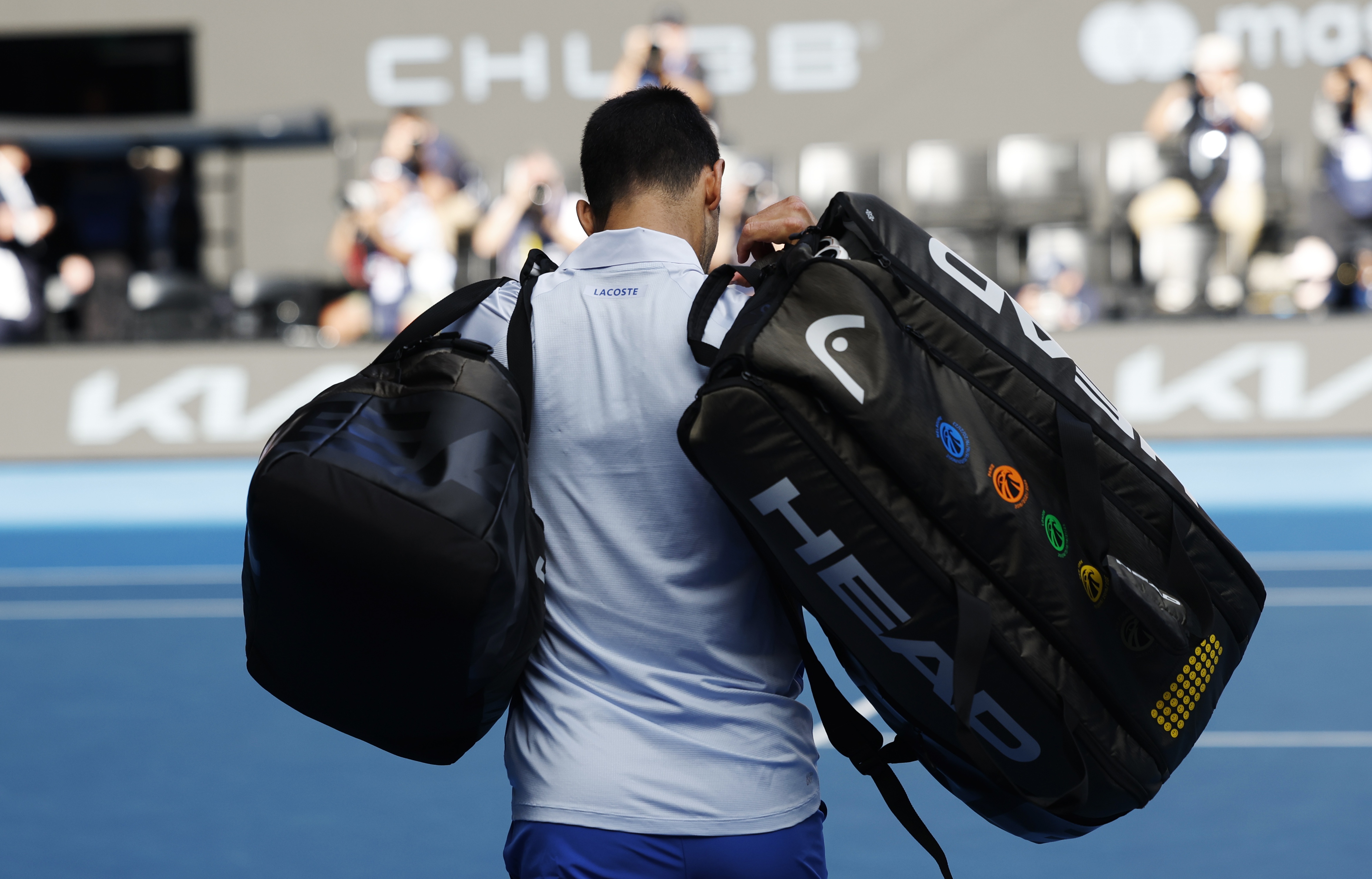 epa11105028 Novak Djokovic of Serbia leaves the court after being defeated by Jannik Sinner of Italy in the Men's semi final match at the Australian Open tennis tournament in Melbourne, Australia, 26 January 2024.  EPA-EFE/MAST IRHAM