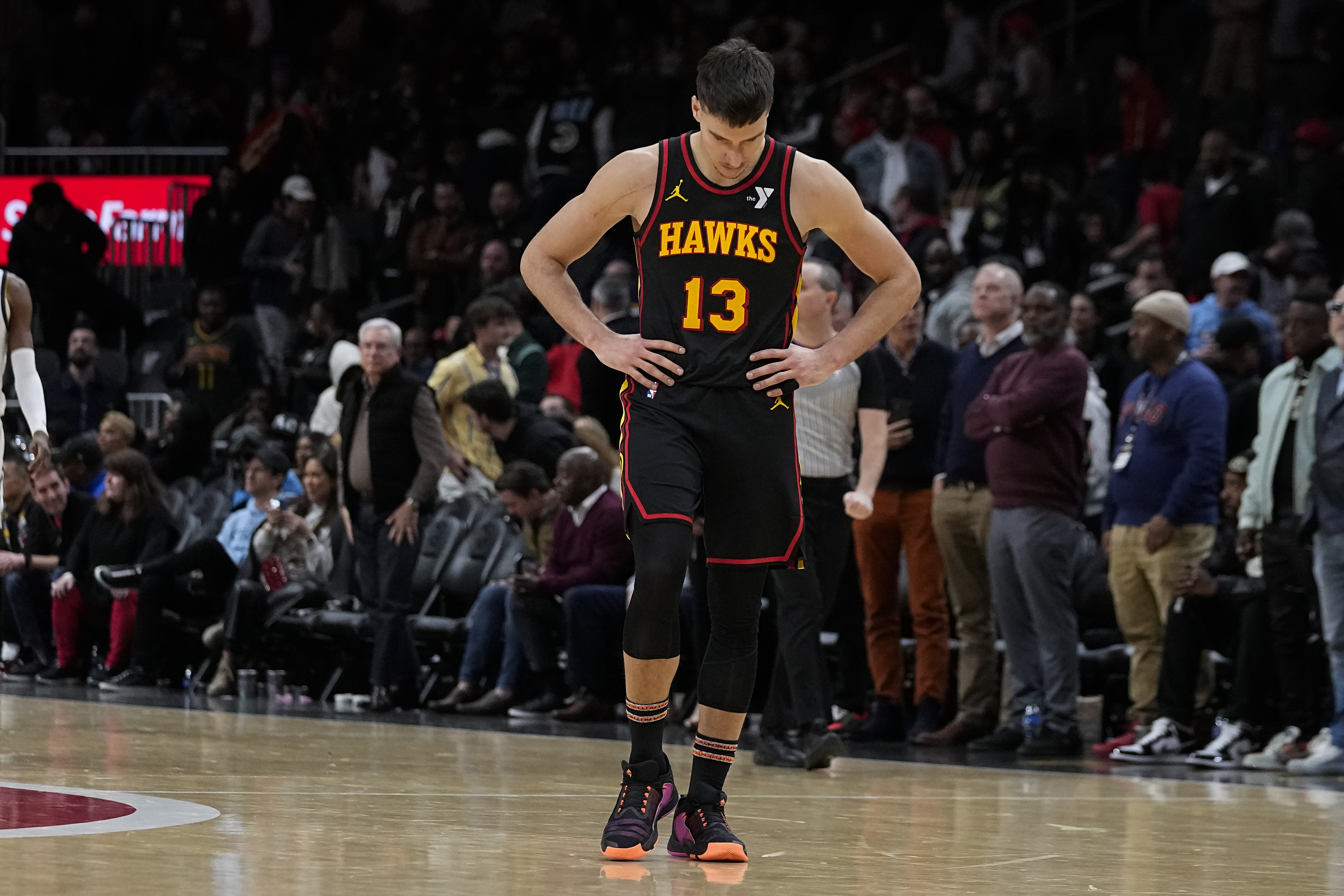 Atlanta Hawks guard Bogdan Bogdanovic walks on the court in the fianl moments of thier loss to the Denver Nuggets in an NBA basketball game, Monday, Dec. 11, 2023, in Atlanta. (AP Photo/John Bazemore)