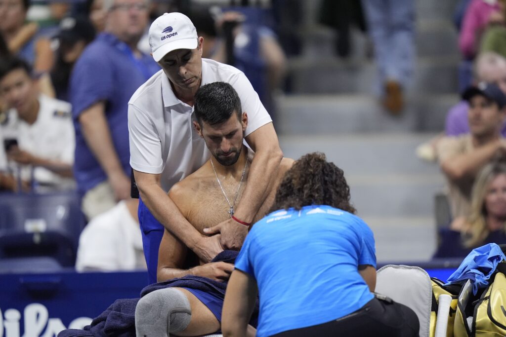 Novak Djokovic, of Serbia, gets treatment during a second round match against Laslo Djere, of Serbia, of the U.S. Open tennis championships, Wednesday, Aug. 28, 2024, in New York. (AP Photo/Frank Franklin II)
