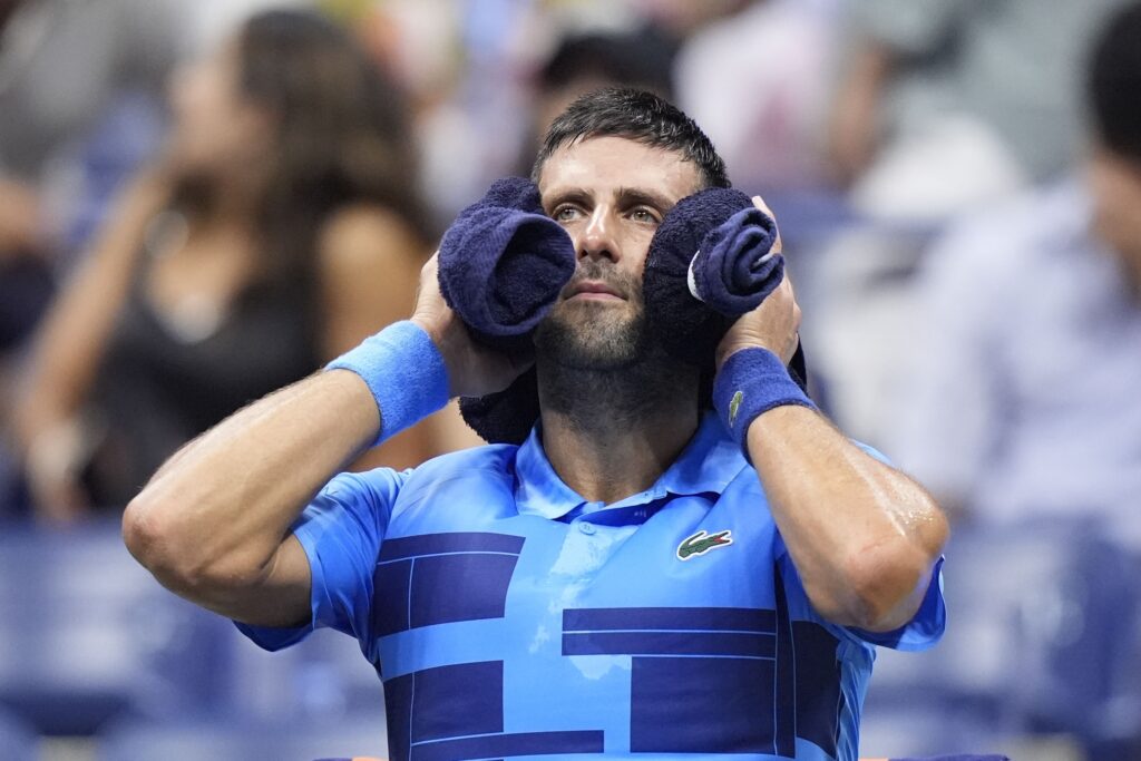Novak Djokovic, of Serbia, puts a towel around his neck nduring a second round match against Laslo Djere, of Serbia, of the U.S. Open tennis championships, Wednesday, Aug. 28, 2024, in New York. (AP Photo/Frank Franklin II)