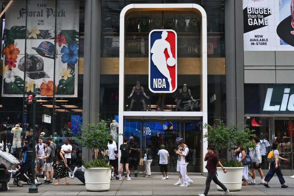 People walk past an NBA fan store with the NBA logo in New York on July 8, 2024.,Image: 888314360, License: Rights-managed, Restrictions: , Model Release: no, Credit line: ANGELA WEISS / AFP / Profimedia