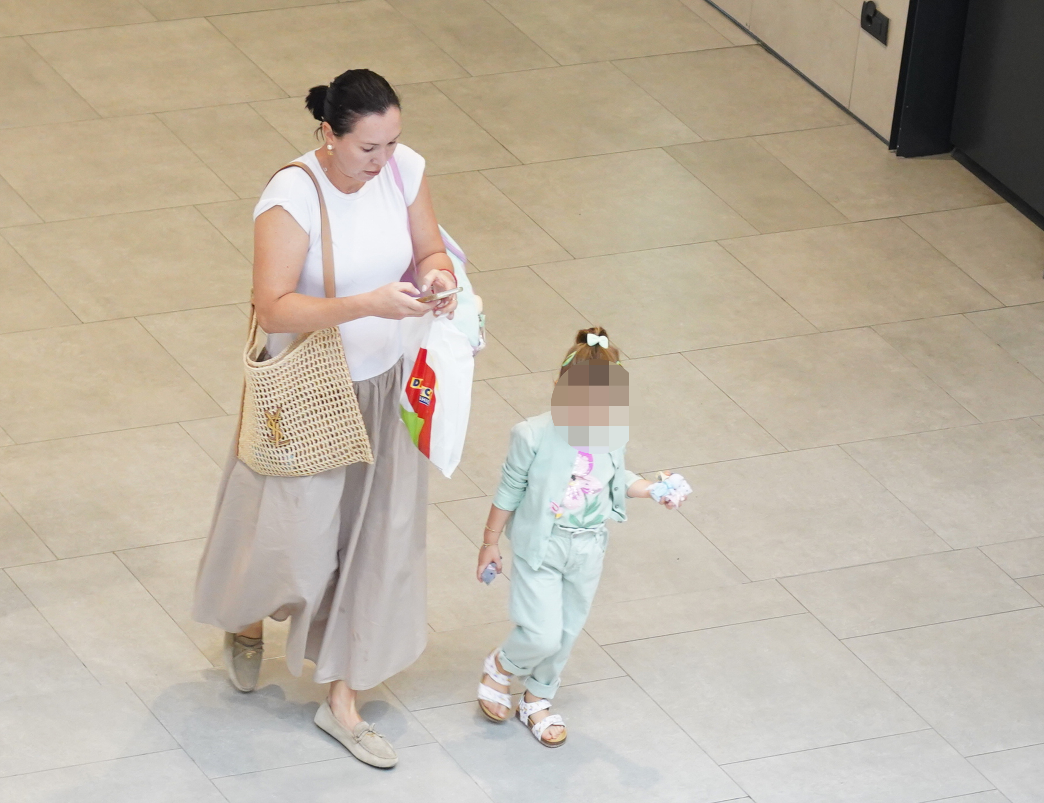Former Serbian tennis player, former world number 1 Jelena Jankovic walking with her daughter Una in one of the Belgrade shopping centers.
