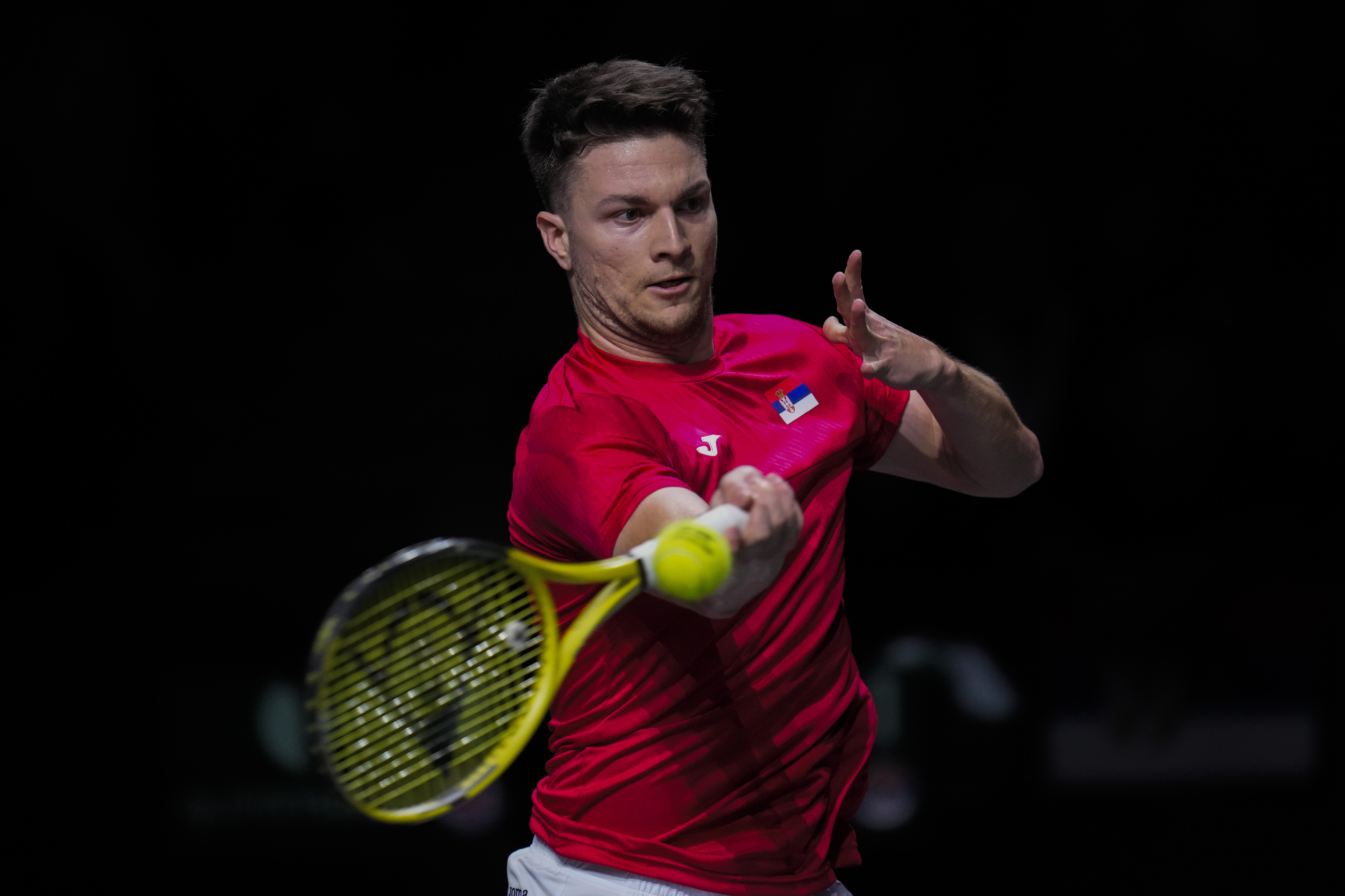Serbia's Miomir Kecmanovic plays a shot against Britain's Jack Draper during a Davis Cup quarter-final tennis match between Serbia and United Kingdom in Malaga, Spain, Thursday, Nov. 23, 2023. (AP Photo/Manu Fernandez)