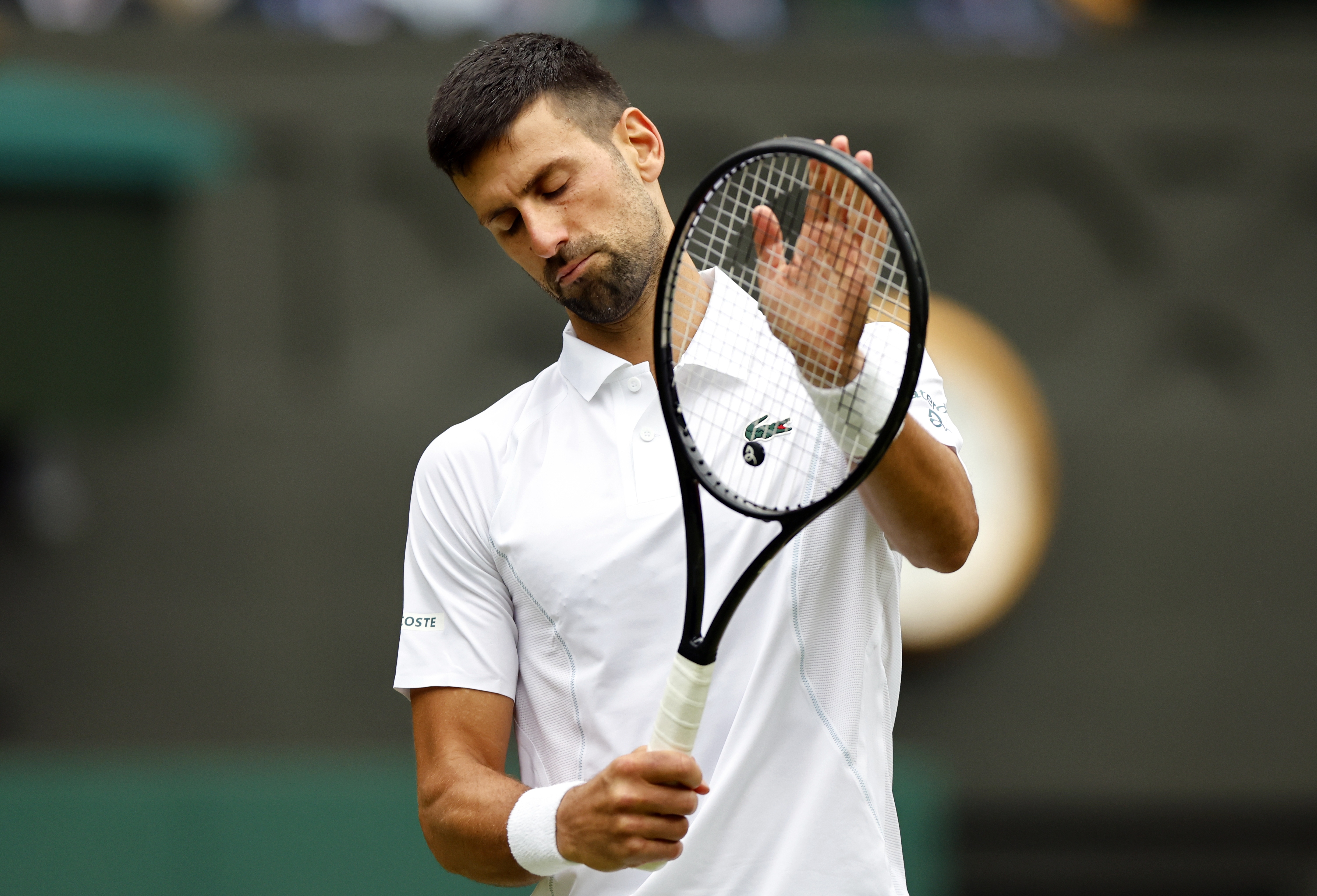 epa11474920 Novak Djokovic of Serbia reacts during the Men's semifinal match against Lorenzo Musetti of Italy at the Wimbledon Championships, Wimbledon, Britain, 12 July 2024.  EPA-EFE/TOLGA AKMEN  EDITORIAL USE ONLY
