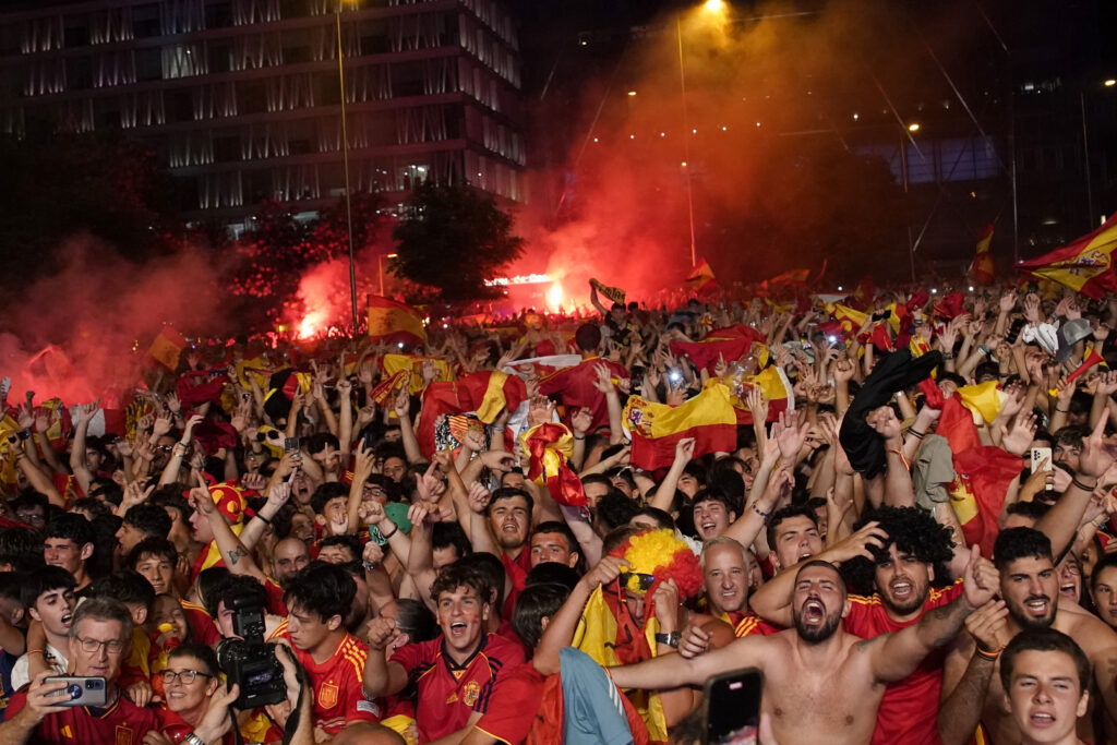 Spain supporters celebrate their country's victory over England in the Euro 2024 soccer tournament final from Madrid, Spain, July 14, 2024. (AP Photo/Andrea Comas)