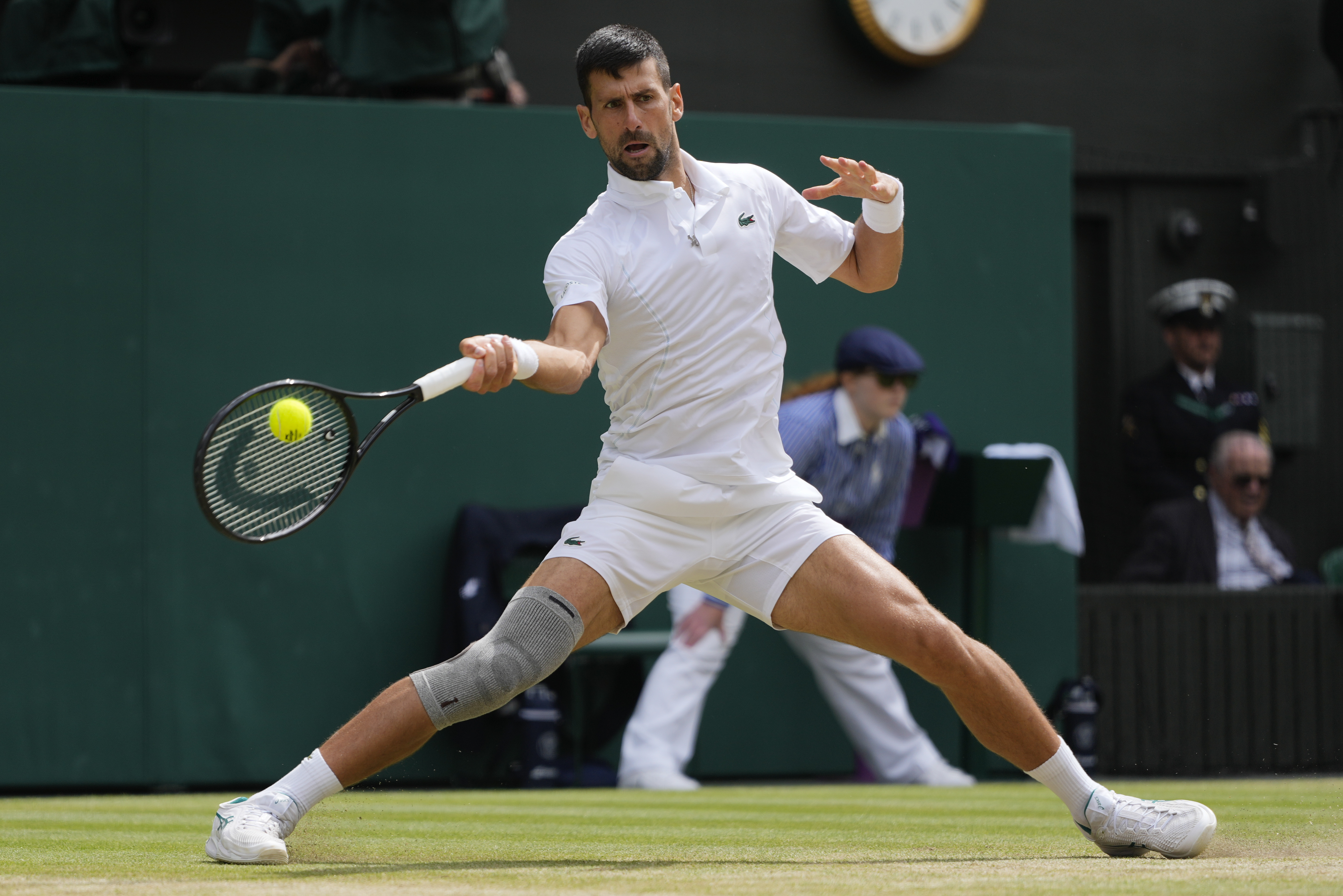 Novak Djokovic of Serbia plays a forehand return to Carlos Alcaraz of Spain during the men's singles final at the Wimbledon tennis championships in London, Sunday, July 14, 2024. (AP Photo/Kirsty Wigglesworth)