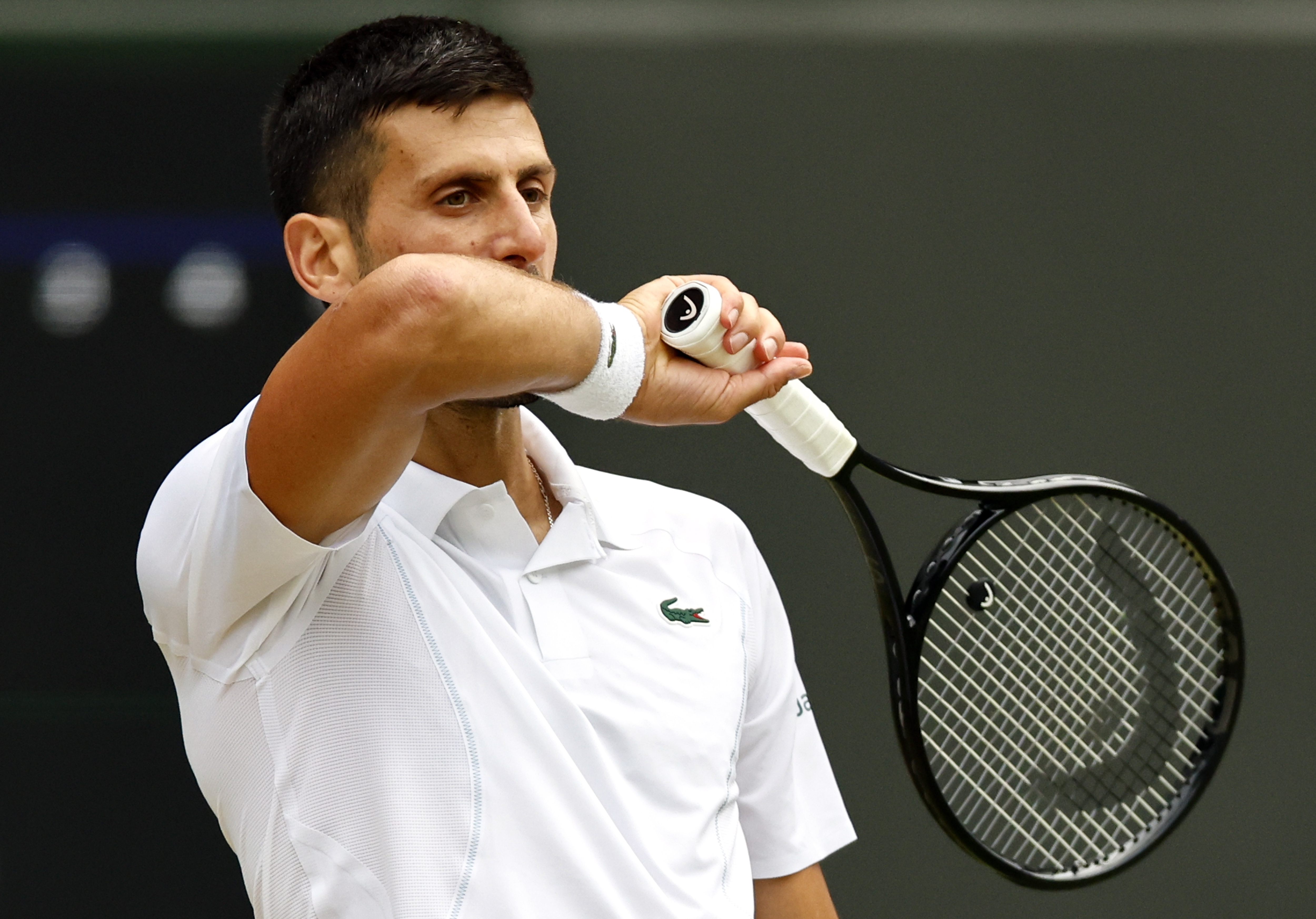 epa11474878 Novak Djokovic of Serbia reacts during the Men's semifinal match against Lorenzo Musetti of Italy at the Wimbledon Championships, Wimbledon, Britain, 12 July 2024.  EPA-EFE/TOLGA AKMEN  EDITORIAL USE ONLY