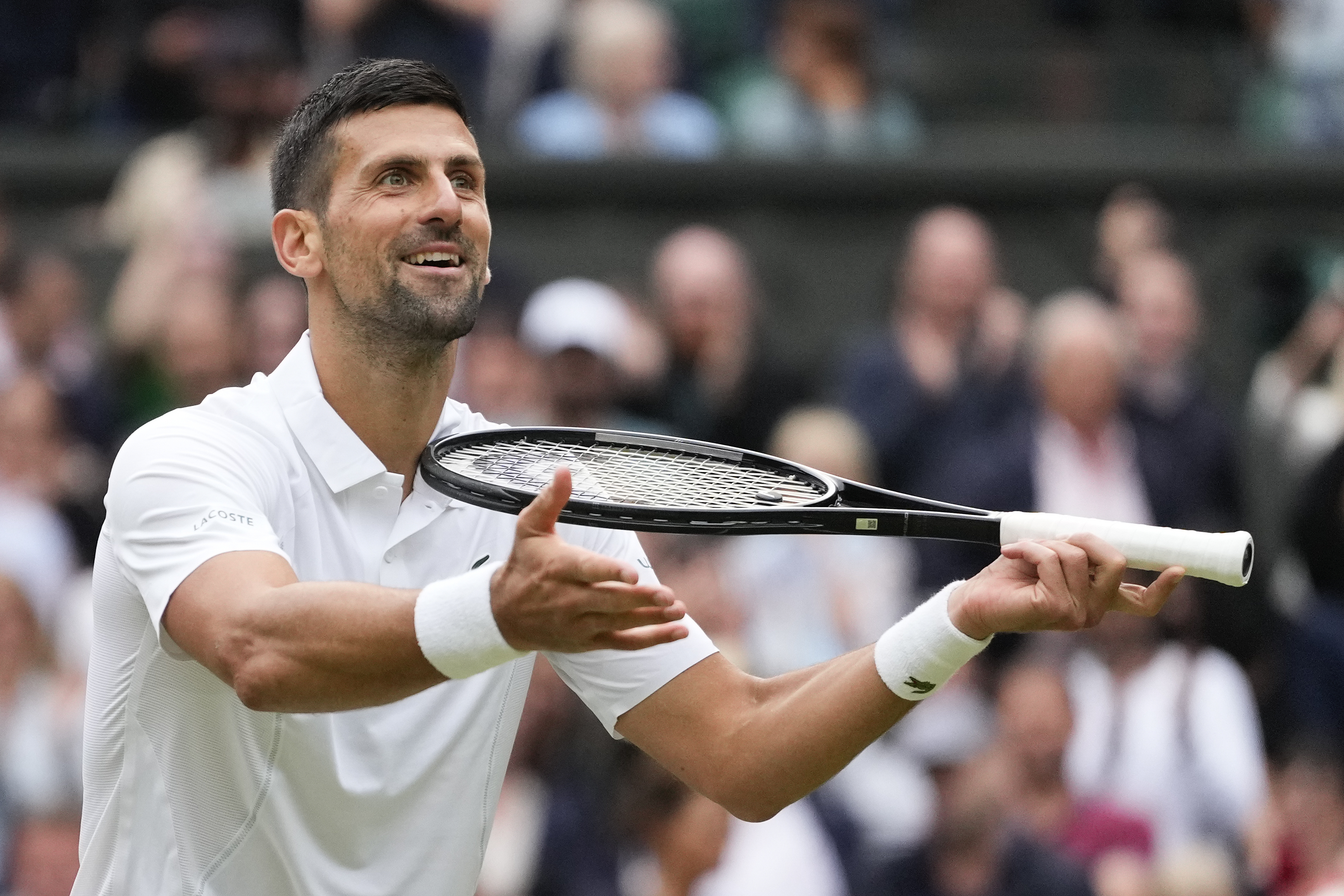 Novak Djokovic of Serbia reacts after defeating Lorenzo Musetti of Italy in their semifinal match at the Wimbledon tennis championships in London, Friday, July 12, 2024. (AP Photo/Kirsty Wigglesworth)