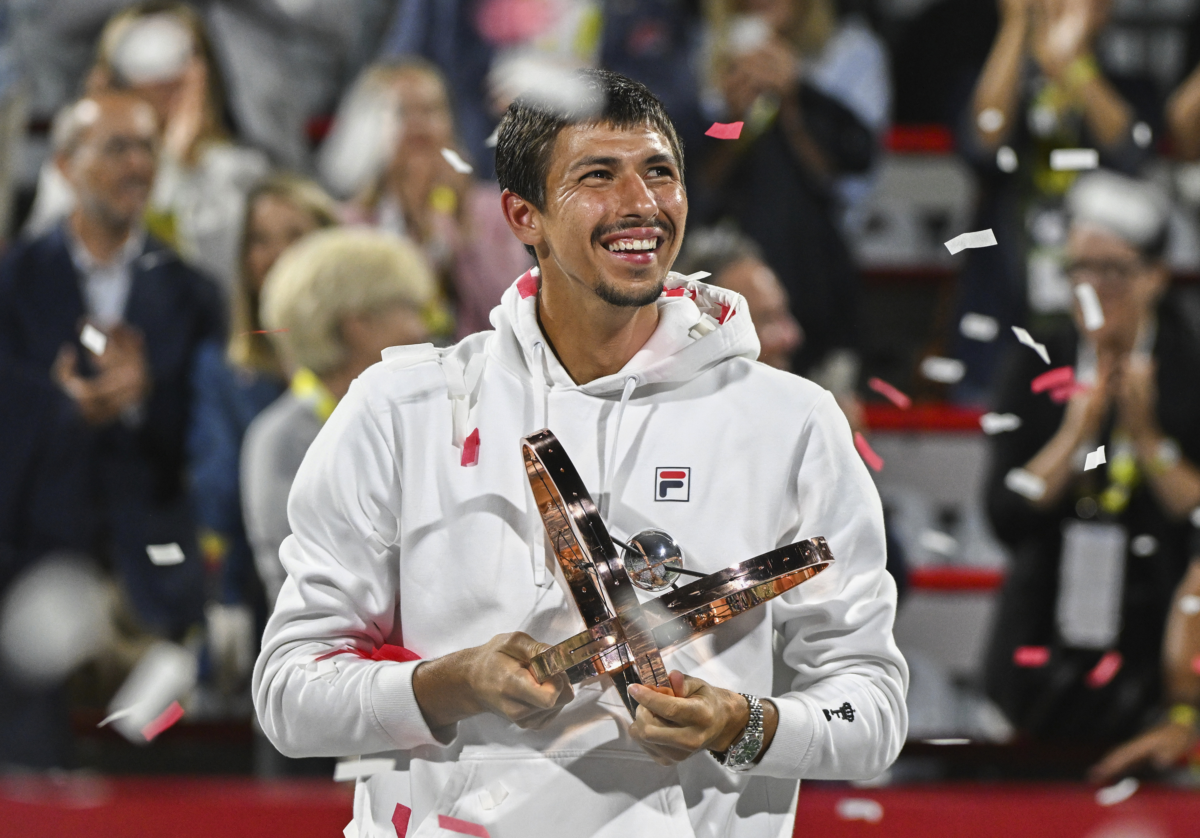 Alexei Popyrin, of Australia, holds the winner's trophy after defeating Andrey Rublev, of Russia, in the final of the National Bank Open men's tennis tournament in Montreal, Monday, Aug. 12, 2024. (Graham Hughes/The Canadian Press via AP)