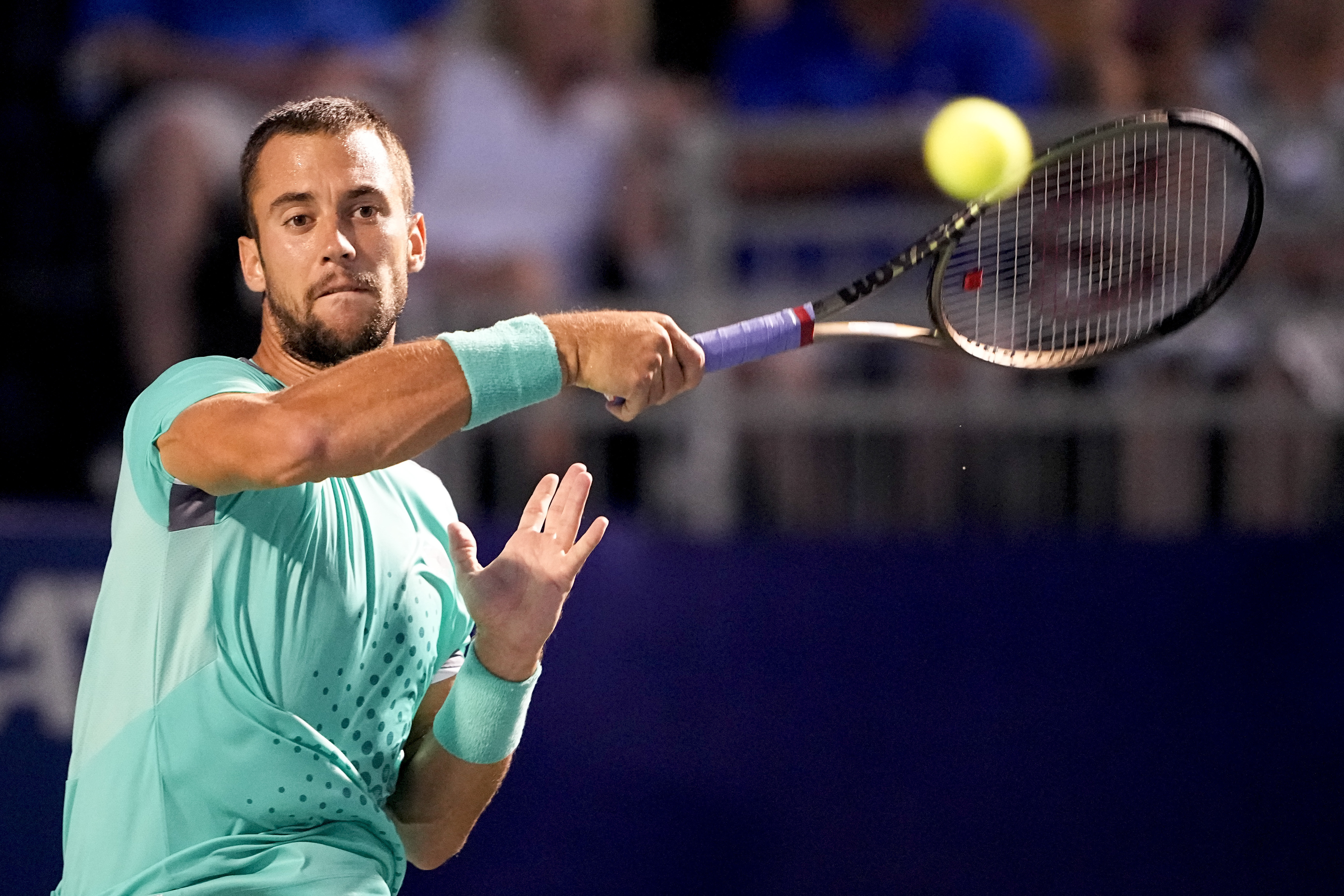 Laslo Djere, of Serbia, returns a shot against Richard Gasquet, of France, during the Winston-Salem Open tennis tournament on Thursday, Aug. 25, 2022, in Winston-Salem, N.C. (AP Photo/Chris Carlson)