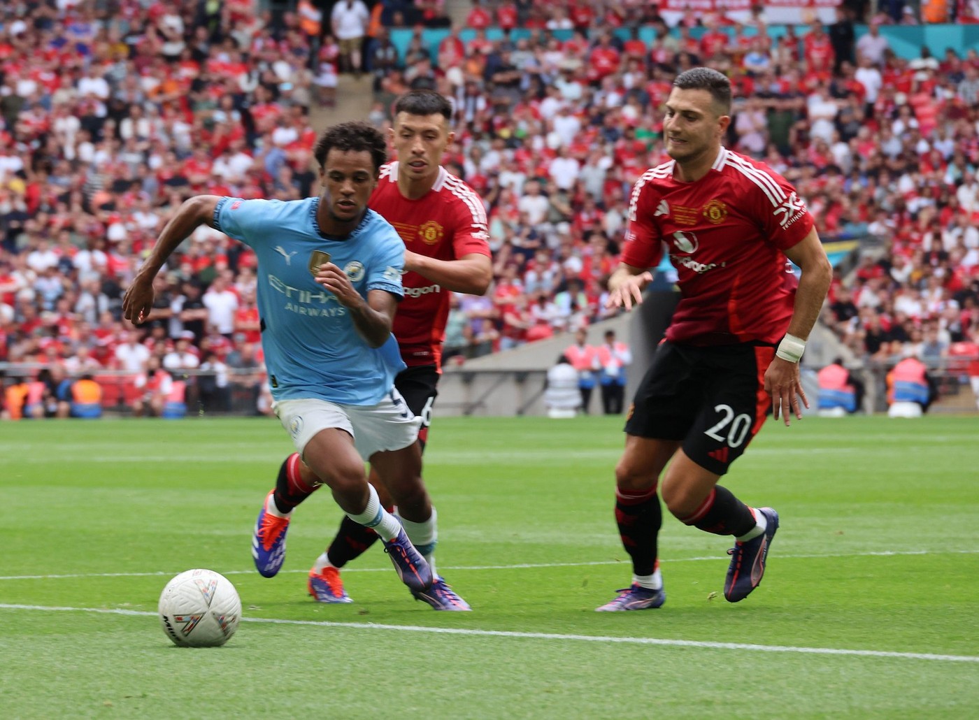 London, UK. 10th Aug, 2024. LONDON, ENGLAND - AUGUST 10: L-R Oscar Bobb of Manchester City and Manchester United's Diogo Dalot in action during The FA Community Shield between Manchester City and Manchester United at Wembley Stadium on August 10th, 2024 i