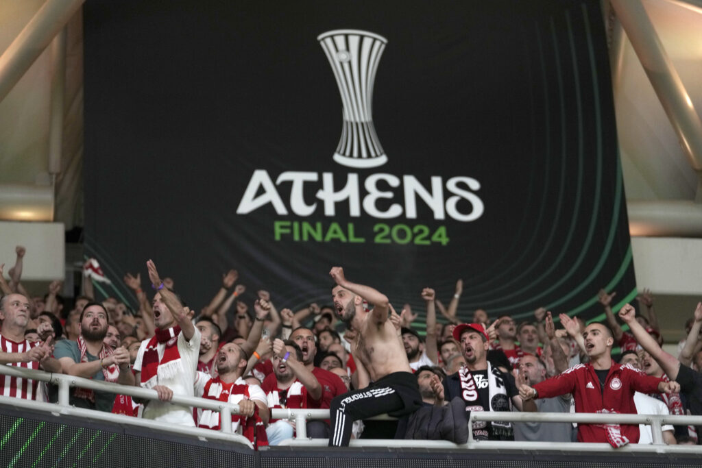 Olympiacos supporters cheer on their team players before the Conference League final soccer match between Olympiacos FC and ACF Fiorentina at OPAP Arena in Athens, Greece, Wednesday, May 29, 2024. (AP Photo/Petros Giannakouris)