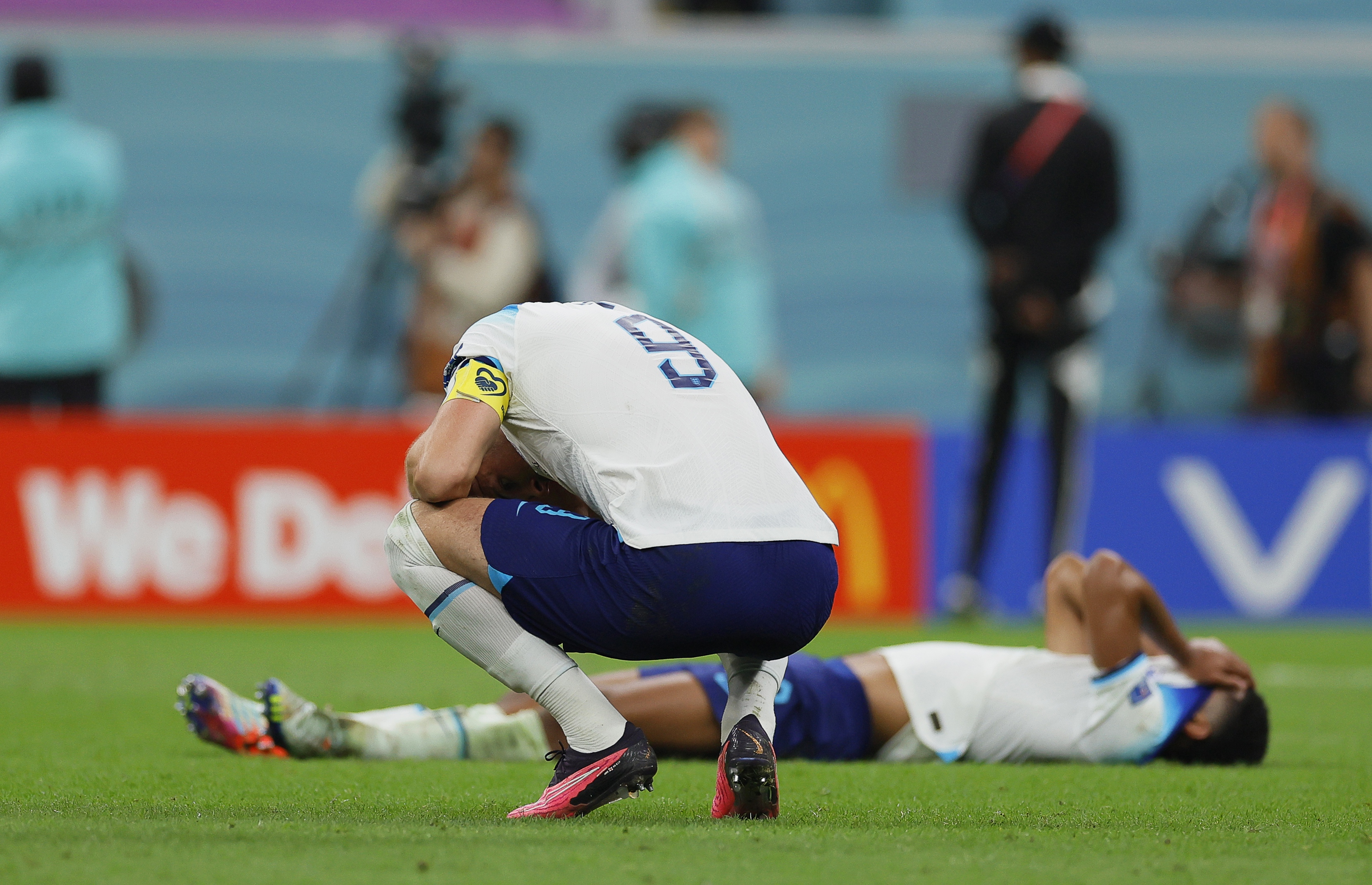 epa10360426 Harry Kane (front) of England reacts after losing the FIFA World Cup 2022 quarter final soccer match between England and France at Al Bayt Stadium in Al Khor, Qatar, 10 December 2022.  EPA-EFE/Ronald Wittek