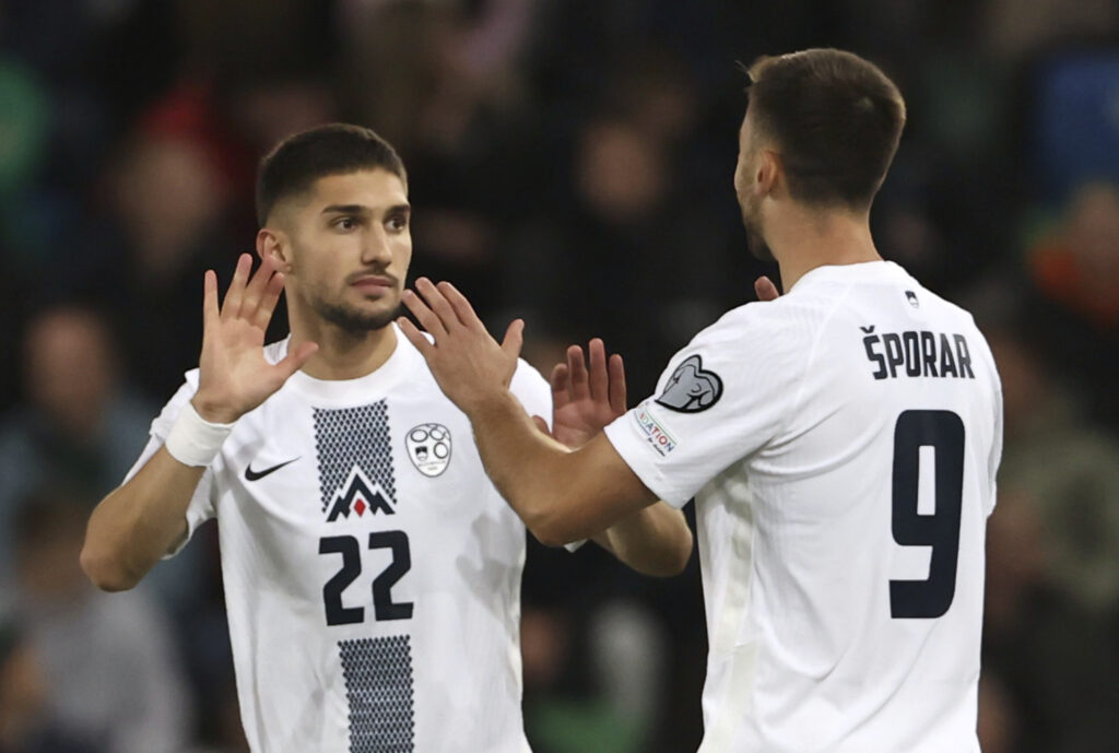 Slovenia's Adam Cerin, left, celebrates scoring the opening goal during the Euro 2024 qualifying, group H, soccer match between Northern Ireland and Slovenia, at Windsor Park, in Belfast, Northern Ireland, Tuesday, Oct. 17, 2023. (Liam McBurney/PA via AP)