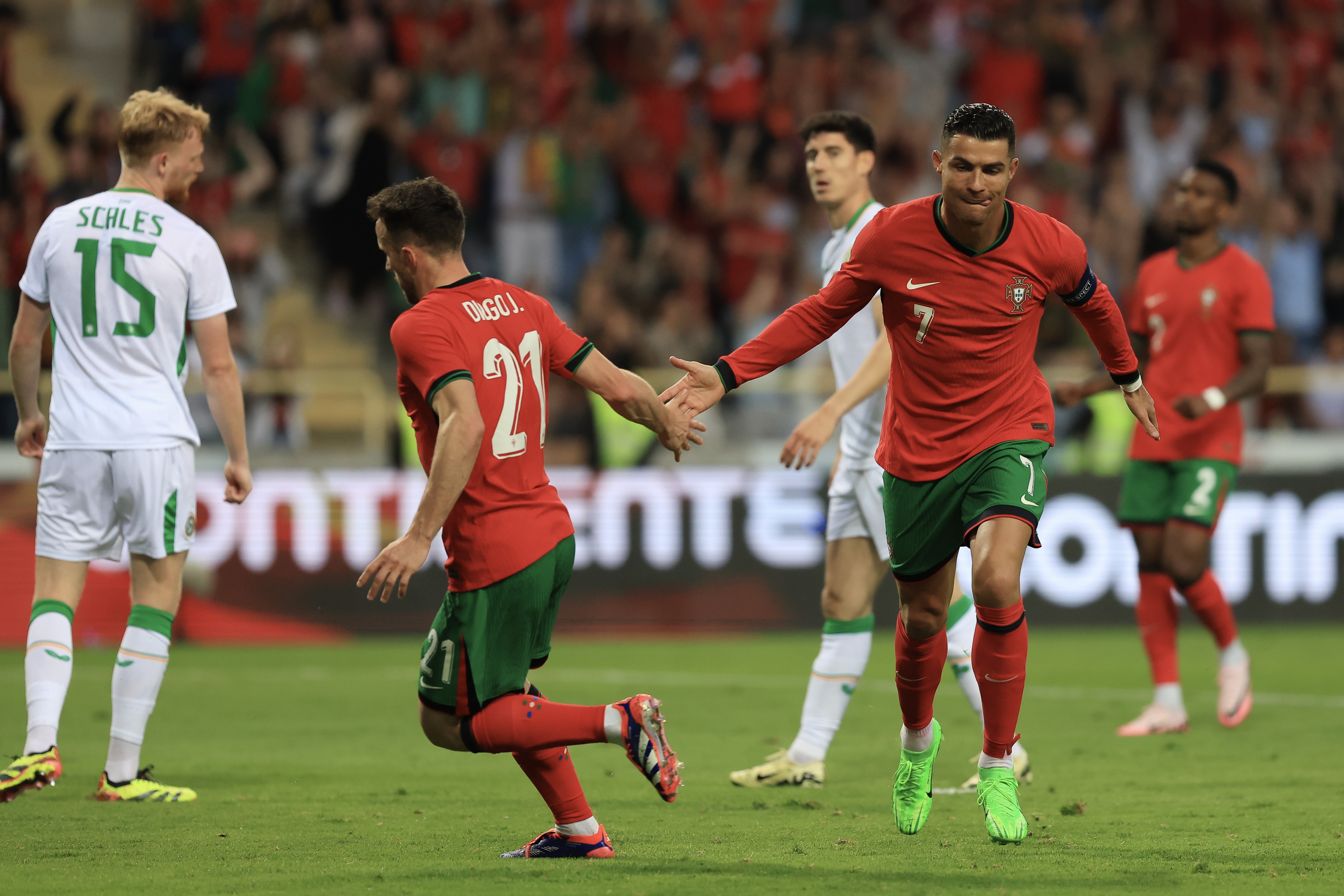 epa11404842 Portugal's Cristiano Ronaldo (R) celebrates with Diogo Jota after scoring a goal during the friendly international soccer match between Portugal and Ireland in Aveiro, Portugal, 11 June 2024.  EPA-EFE/JOSE COELHO