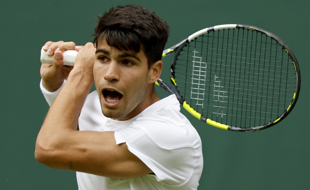 epa11449923 Carlos Alcaraz of Spain in action during the Men's 1st round match against Mark Lajal of Estonia at the Wimbledon Championships, Wimbledon, Britain, 01 July 2024.  EPA-EFE/TOLGA AKMEN   EDITORIAL USE ONLY