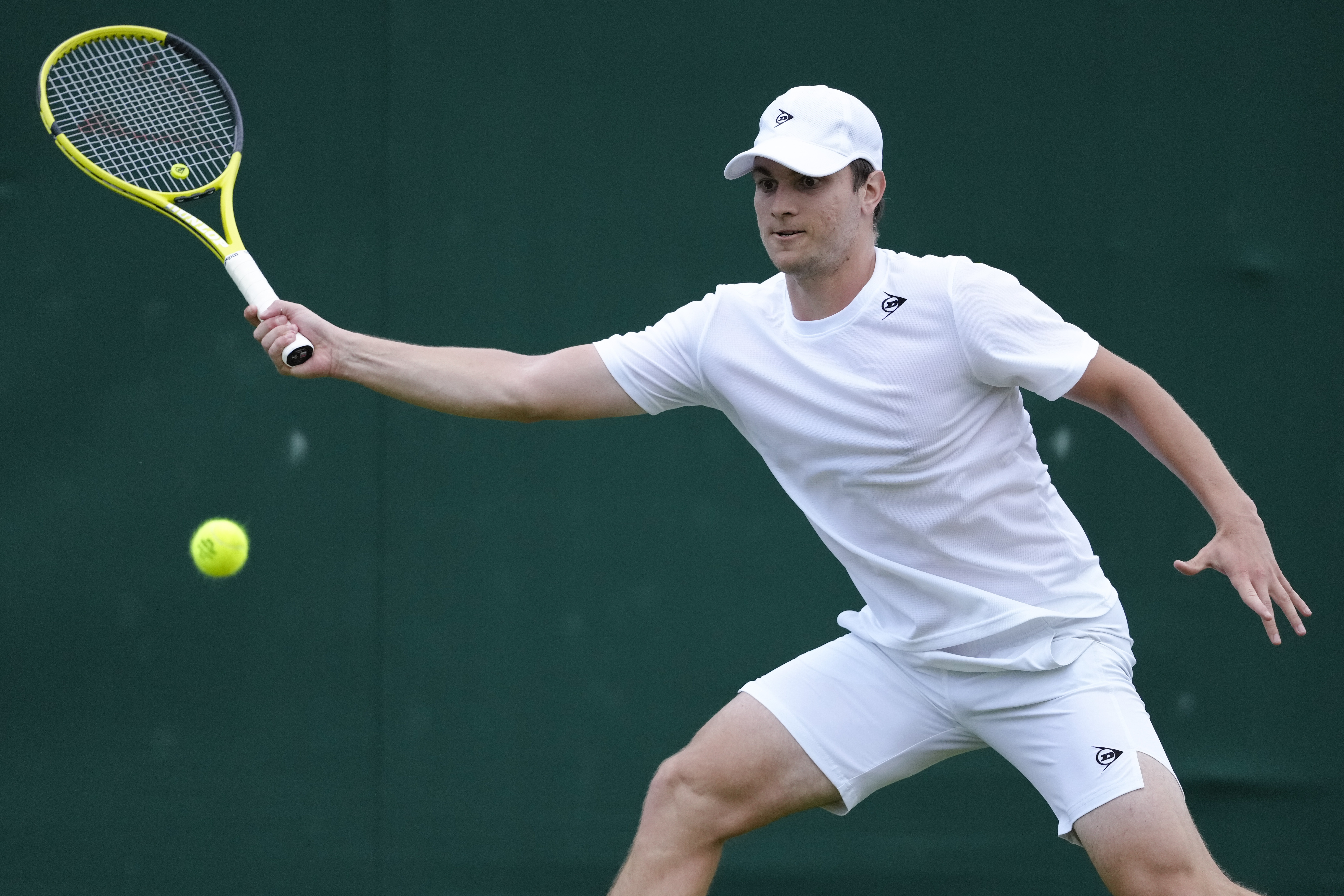 Miomir Kecmanovic of Serbia plays a forehand return to Sumit Nagal of India during their first round match of the Wimbledon tennis championships in London, Monday, July 1, 2024. (AP Photo/Kirsty Wigglesworth)