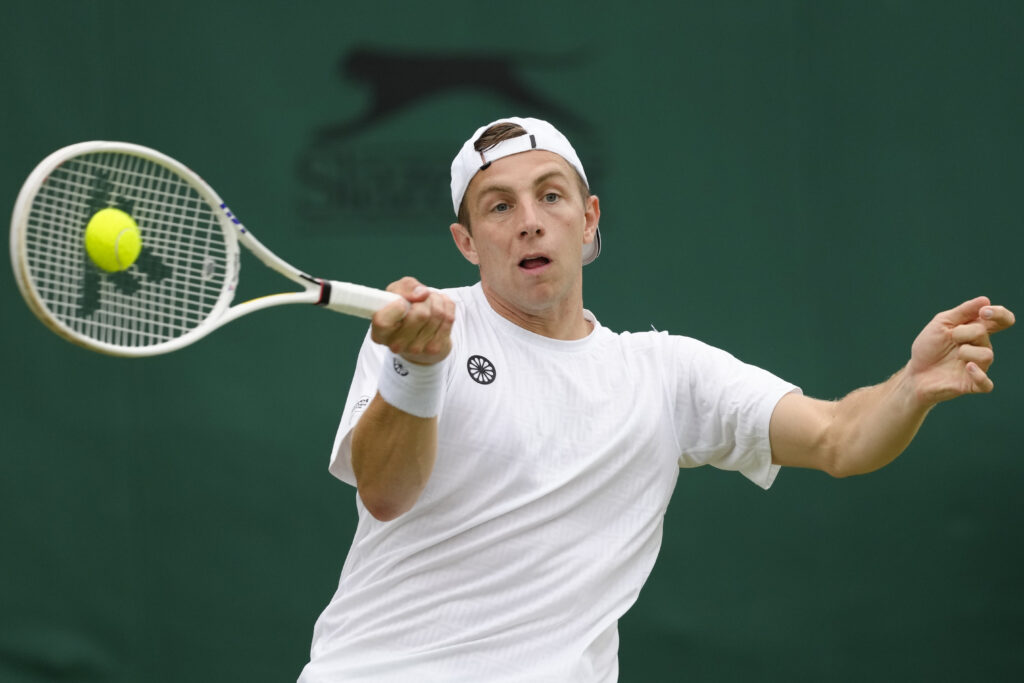 Tallon Griekspoor of the Netherlands plays a forehand return to Miomir Kecmanovic of Serbia during their match on day three at the Wimbledon tennis championships in London, Wednesday, July 3, 2024. (AP Photo/Kirsty Wigglesworth)