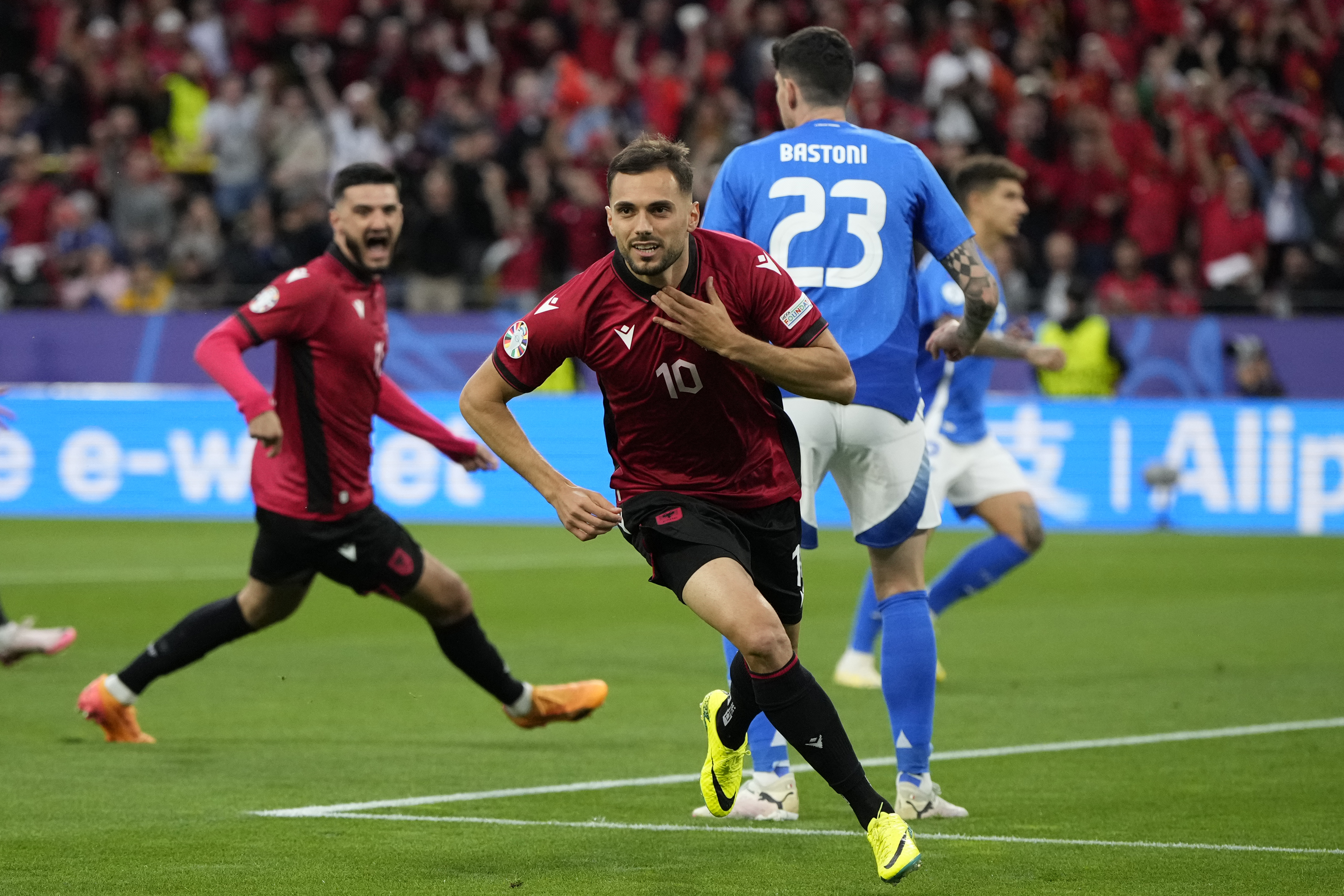Albania's Nedim Bajrami celebrates after scoring his side's opening goal during a Group B match between Italy and Albania at the Euro 2024 soccer tournament in Dortmund, Germany, Saturday, June 15, 2024. (AP Photo/Alessandra Tarantino)
