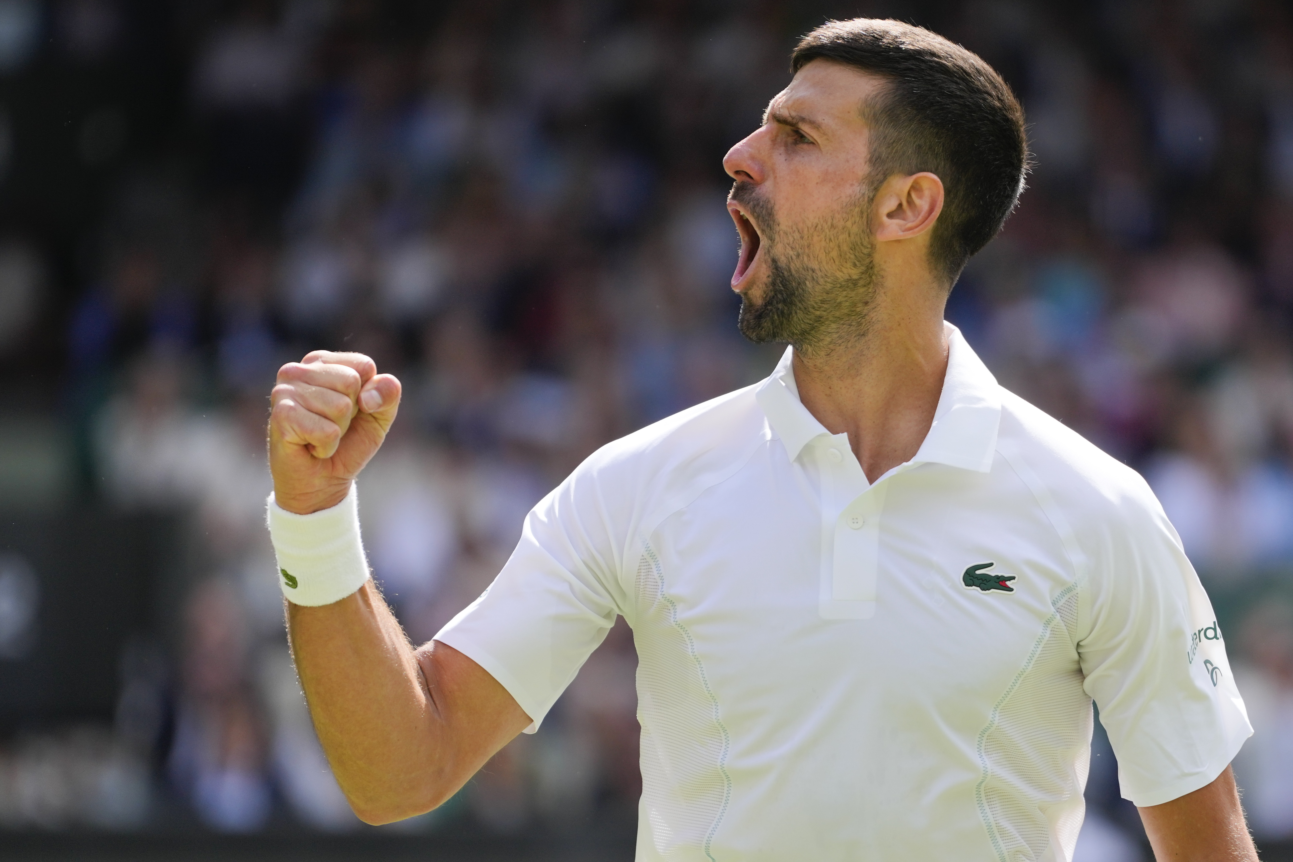 Serbia's Novak Djokovic reacts after winning a point against Britain's Jacob Fearnley during their second round match at the Wimbledon tennis championships in London, Thursday, July 4, 2024. (AP Photo/Kirsty Wigglesworth)