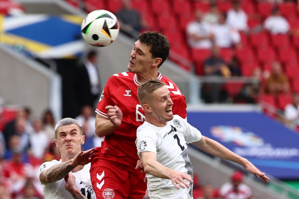 epa11415932 Andreas Christensen (C) of Denmark and Zan Karnicnik (R) of Slovenia in action during the UEFA EURO 2024 Group C soccer match between Slovenia and Denmark, in Stuttgart, Germany, 16 June 2024.  EPA-EFE/ANNA SZILAGYI