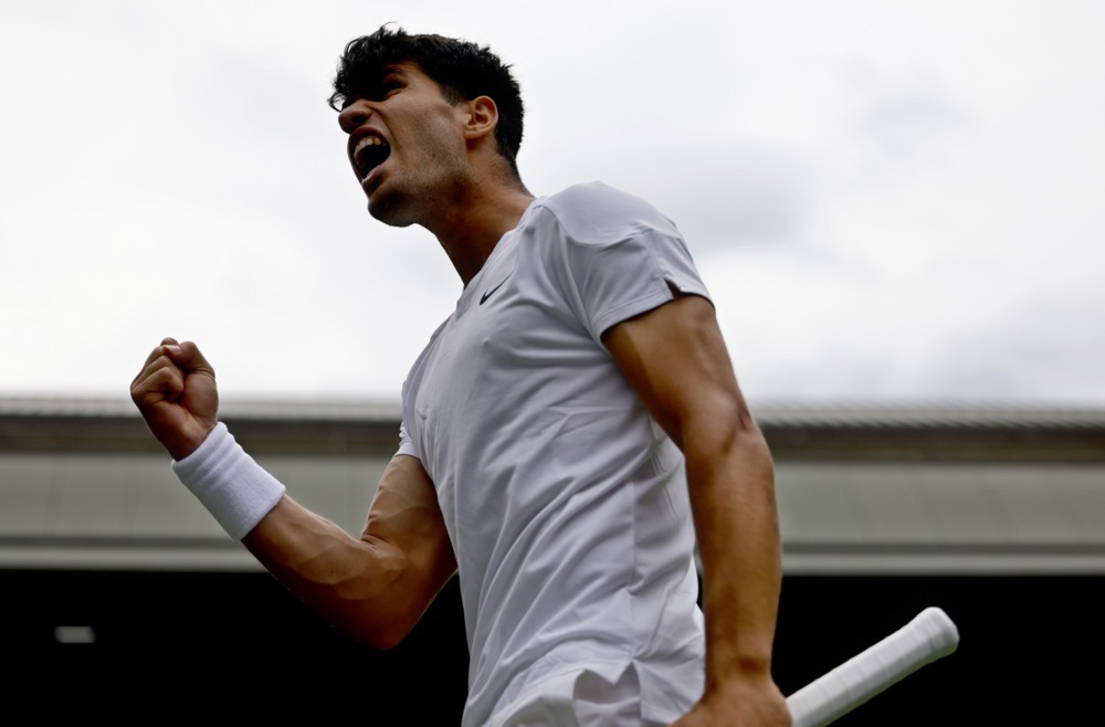 epa11449936 Carlos Alcaraz of Spain celebrates a point during the Men's 1st round match against Mark Lajal of Estonia at the Wimbledon Championships, Wimbledon, Britain, 01 July 2024.  EPA-EFE/TOLGA AKMEN  EDITORIAL USE ONLY