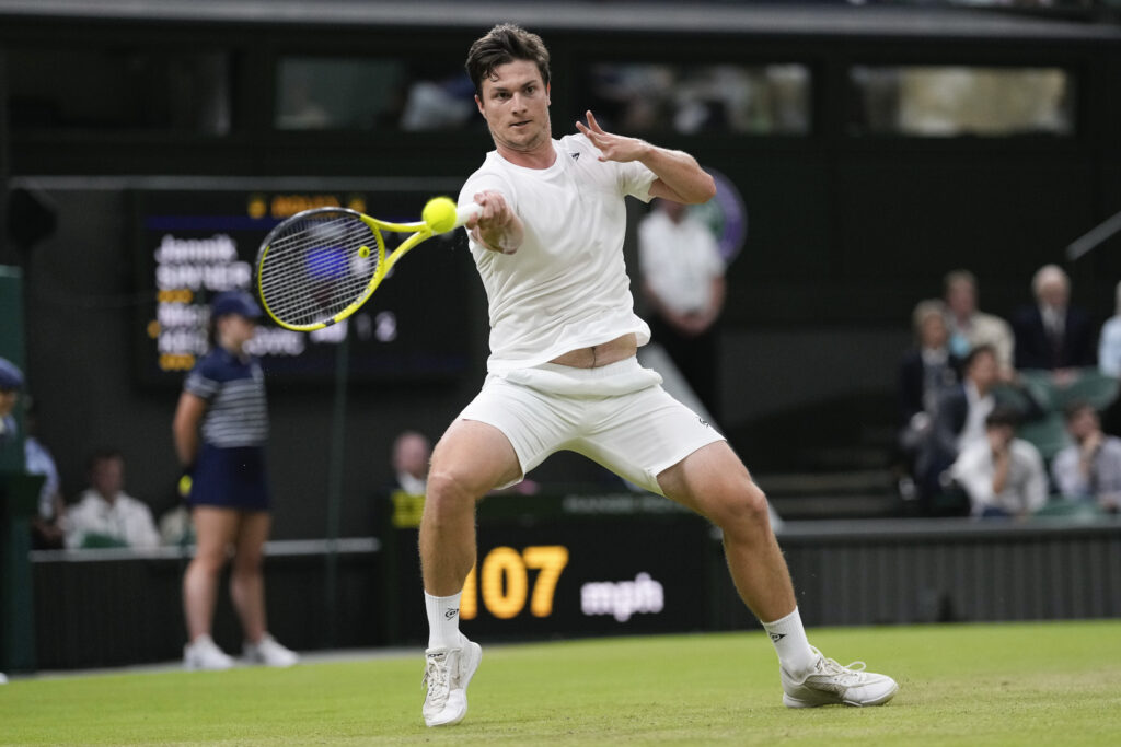 Miomir Kecmanovic of Serbia plays a forehand return to Jannik Sinner of Italy during their third round match at the Wimbledon tennis championships in London, Friday, July 5, 2024. (AP Photo/Alberto Pezzali)