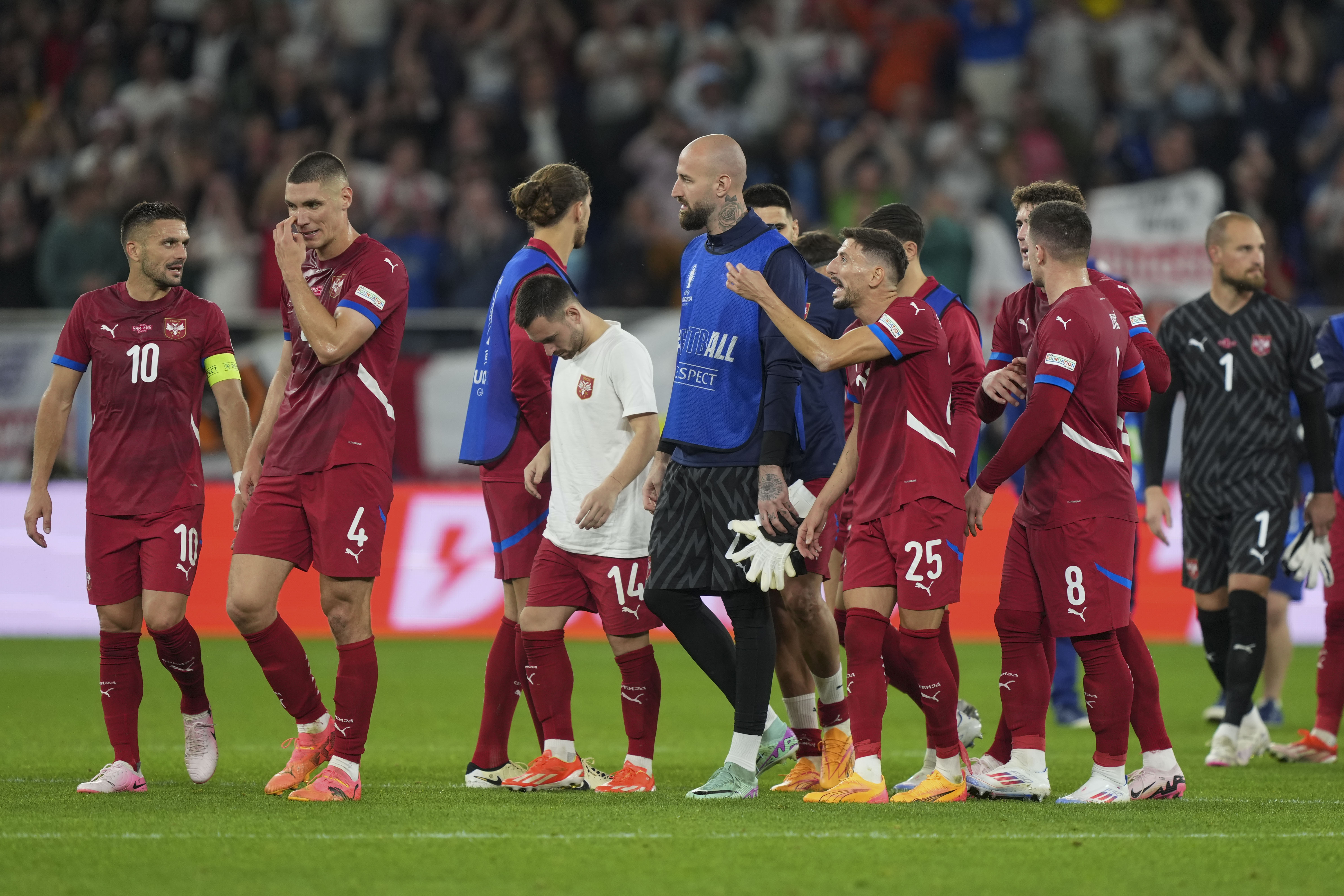 Serbia's players react at the end of a Group C match between Serbia and England at the Euro 2024 soccer tournament in Gelsenkirchen, Germany, Sunday, June 16, 2024. (AP Photo/Martin Meissner)