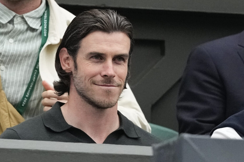 Gareth Bale sits on Centre Court for the fourth round match between Novak Djokovic of Serbia and Hulger Rune of Denmark at the Wimbledon tennis championships in London, Monday, July 8, 2024. (AP Photo/Kirsty Wigglesworth)