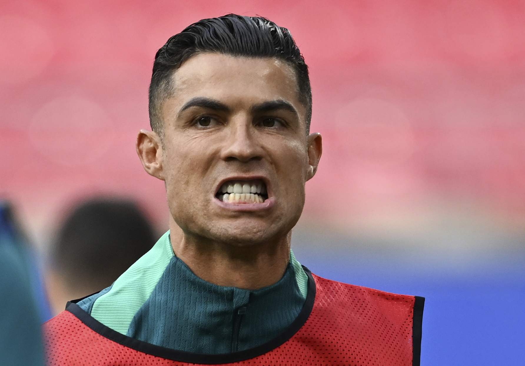 Portugal's Cristiano Ronaldo grimaces during a training session of the national soccer team of Portugal in Leipzig, Germany, Monday, June 17, 2024. (Hendrik Schmidt/dpa via AP)