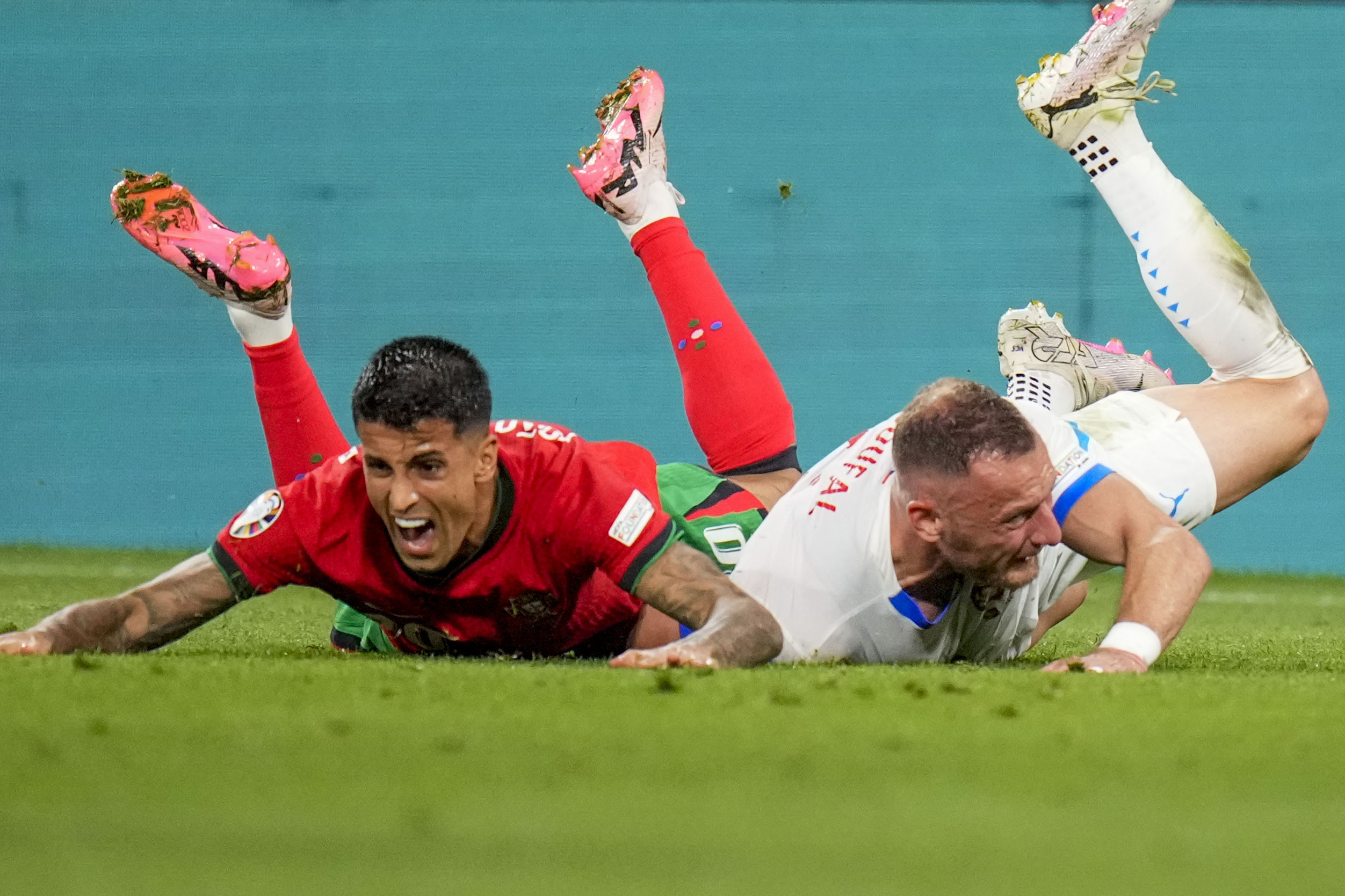 Portugal's Joao Cancelo, left, duels for the ball with Czech Republic's Vladimir Coufal during a Group F match between Portugal and Czech Republic at the Euro 2024 soccer tournament in Leipzig, Germany, Tuesday, June 18, 2024. (AP Photo/Petr Josek)