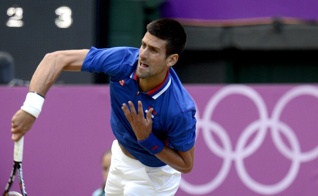 epa03338458 Novak Djokovic of Serbia in action during his men's semi final match against Andy Murray of Britain during the London 2012 Olympic Games Tennis competition in Wimbledon, Greater London, Britain, 03 August 2012.  EPA/ANDY RAIN