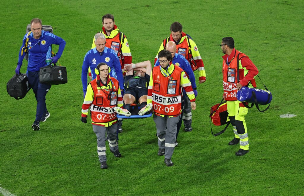 epa11424080 Kieran Tierney of Scotland is stretchered off the pitch during the UEFA EURO 2024 group A soccer match between Scotland and Switzerland, in Cologne, Germany, 19 June 2024.  EPA-EFE/CHRISTOPHER NEUNDORF