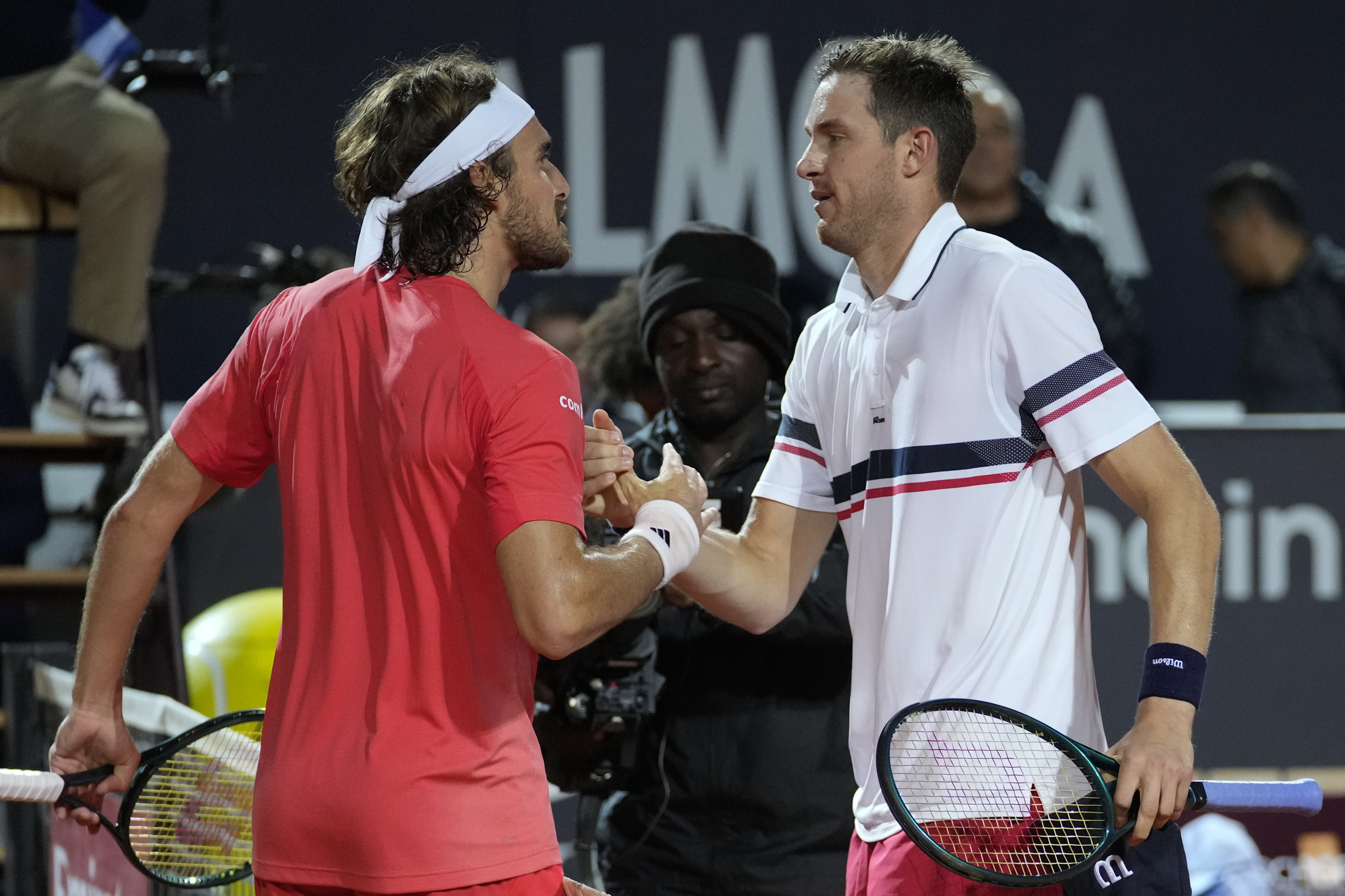Chile's Nicolas Jarry, left, shakes hands with Greece's Stefanos Tsitsipas after he defeated him in a quarter final match at the Italian Open tennis tournament, in Rome, Thursday, May 16, 2024. (AP Photo/Andrew Medichini)