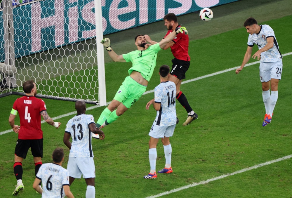 epa11440160 Goalkeeper Giorgi Mamardashvili (C) of Georgia clears the ball during the UEFA EURO 2024 group F soccer match between Georgia and Portugal, in Gelsenkirchen, Germany, 26 June 2024.  EPA-EFE/CHRISTOPHER NEUNDORF