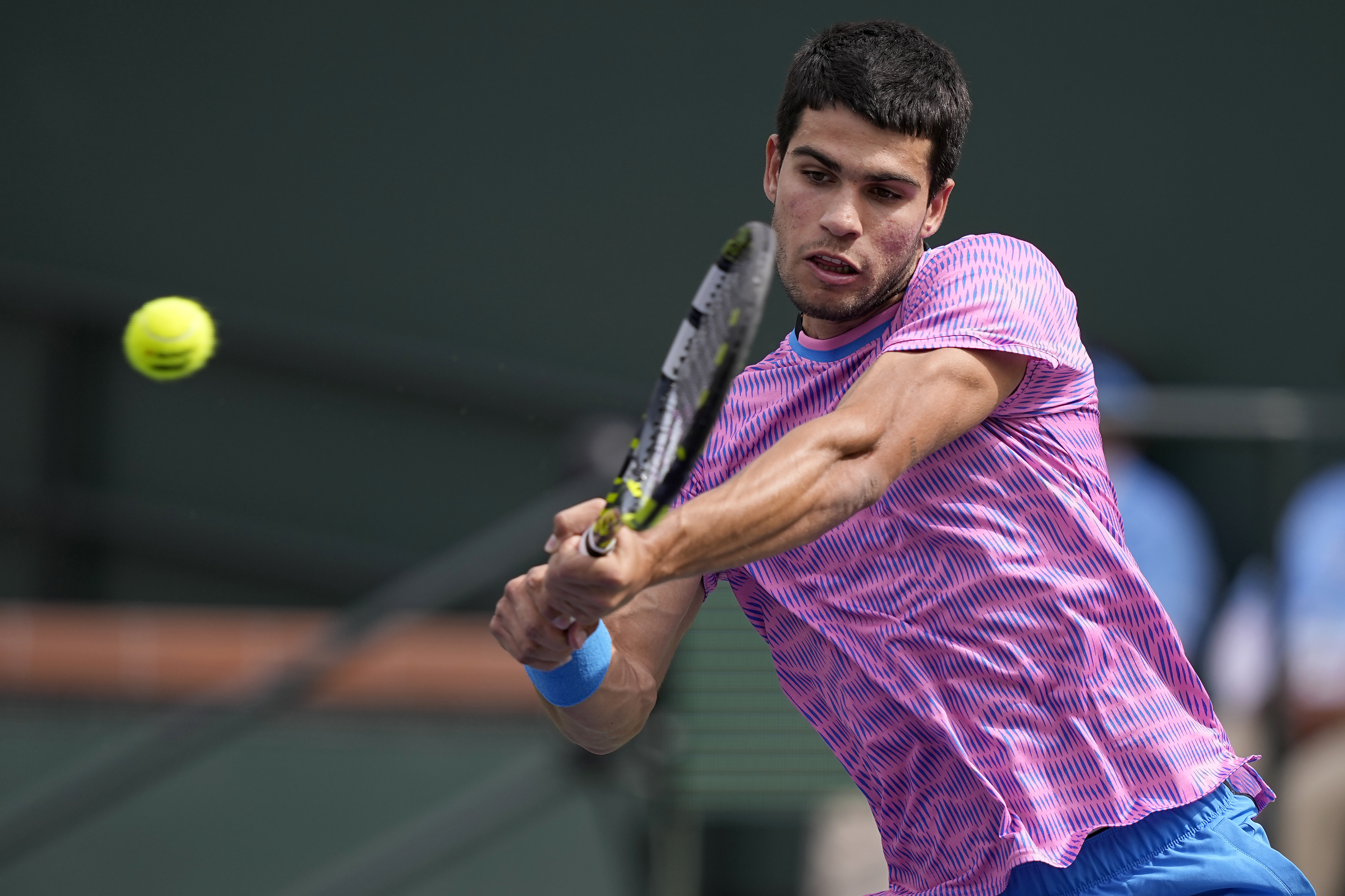 Carlos Alcaraz, of Spain, returns a shot against Felix Auger-Aliassime, of Canada, at the BNP Paribas Open tennis tournament in Indian Wells, Calif., Sunday, March 10, 2024. (AP Photo/Mark J. Terrill)