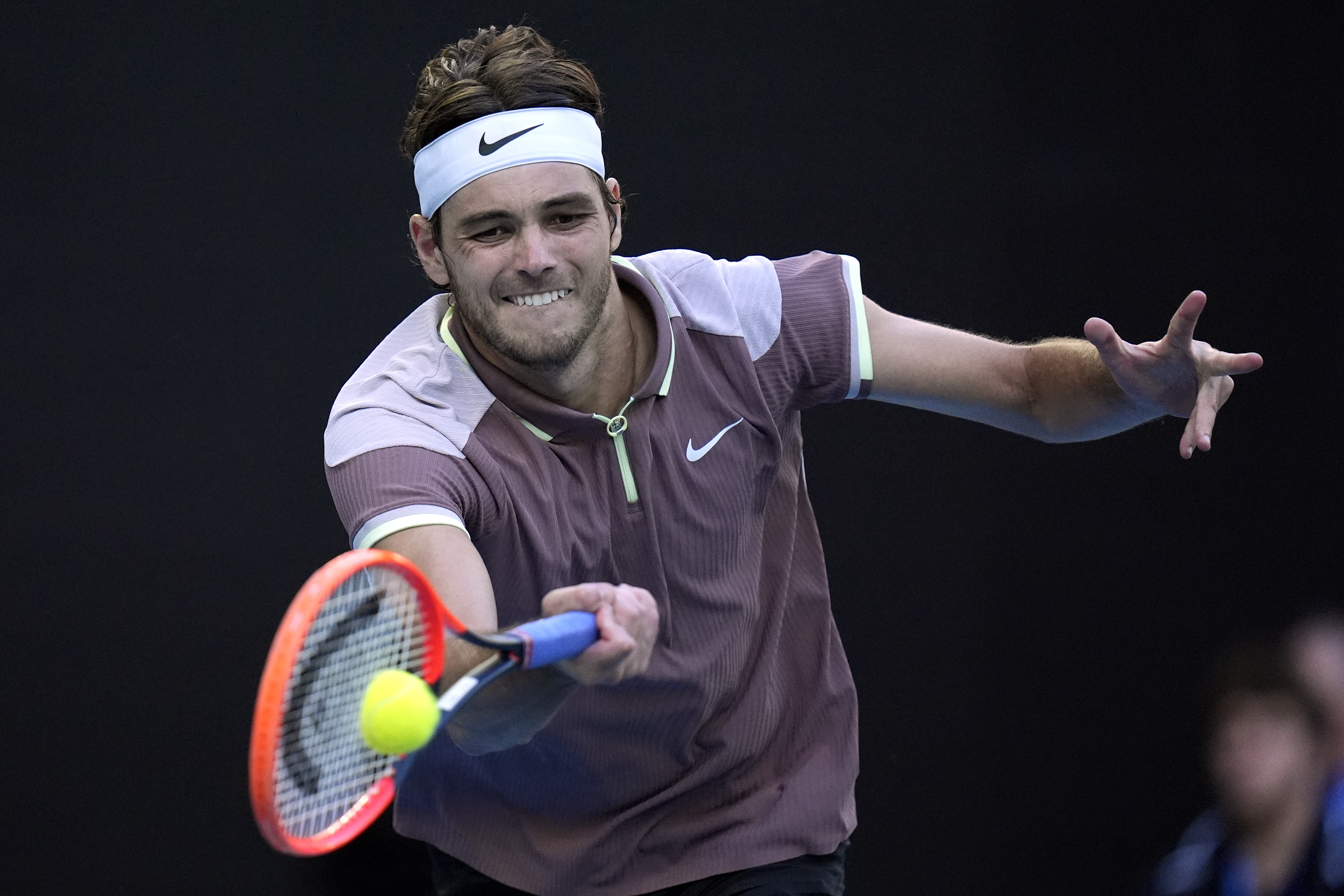 Taylor Fritz of the U.S. plays a forehand return to Novak Djokovic of Serbia during their quarterfinal match at the Australian Open tennis championships at Melbourne Park, Melbourne, Australia, Tuesday, Jan. 23, 2024. (AP Photo/Andy Wong)