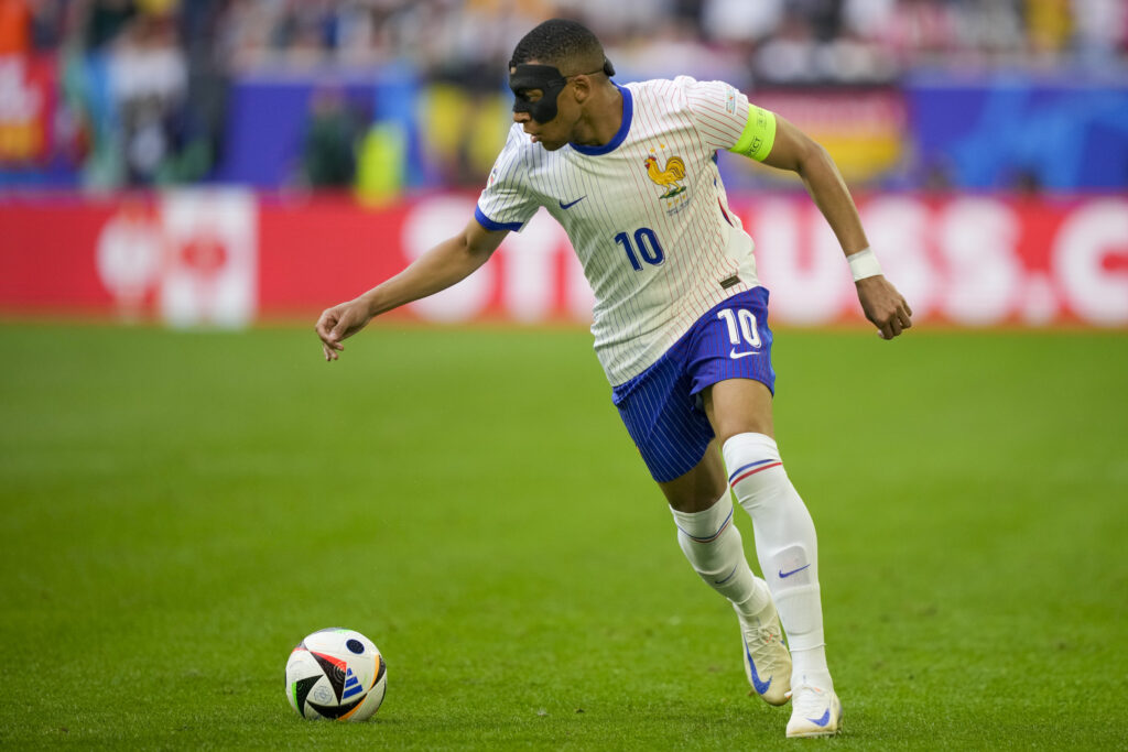 Kylian Mbappe of France runs with the ball during a round of sixteen match between France and Belgium at the Euro 2024 soccer tournament in Duesseldorf, Germany, Monday, July 1, 2024. (AP Photo/Martin Meissner)