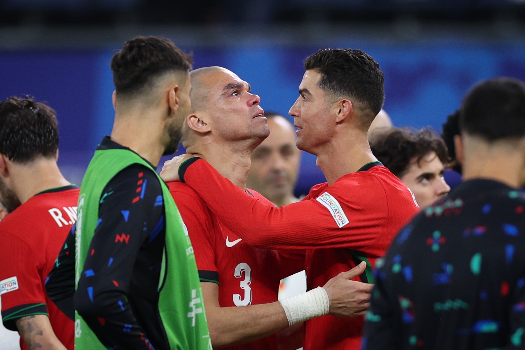epa11461186 Portugal`s Pepe (L) and Cristiano Ronaldo (R) hug after the penalty shoot-out of the UEFA EURO 2024 quarter-finals soccer match between France and Portugal, in Hamburg, Germany, 05 July 2024.  EPA-EFE/MIGUEL A. LOPES