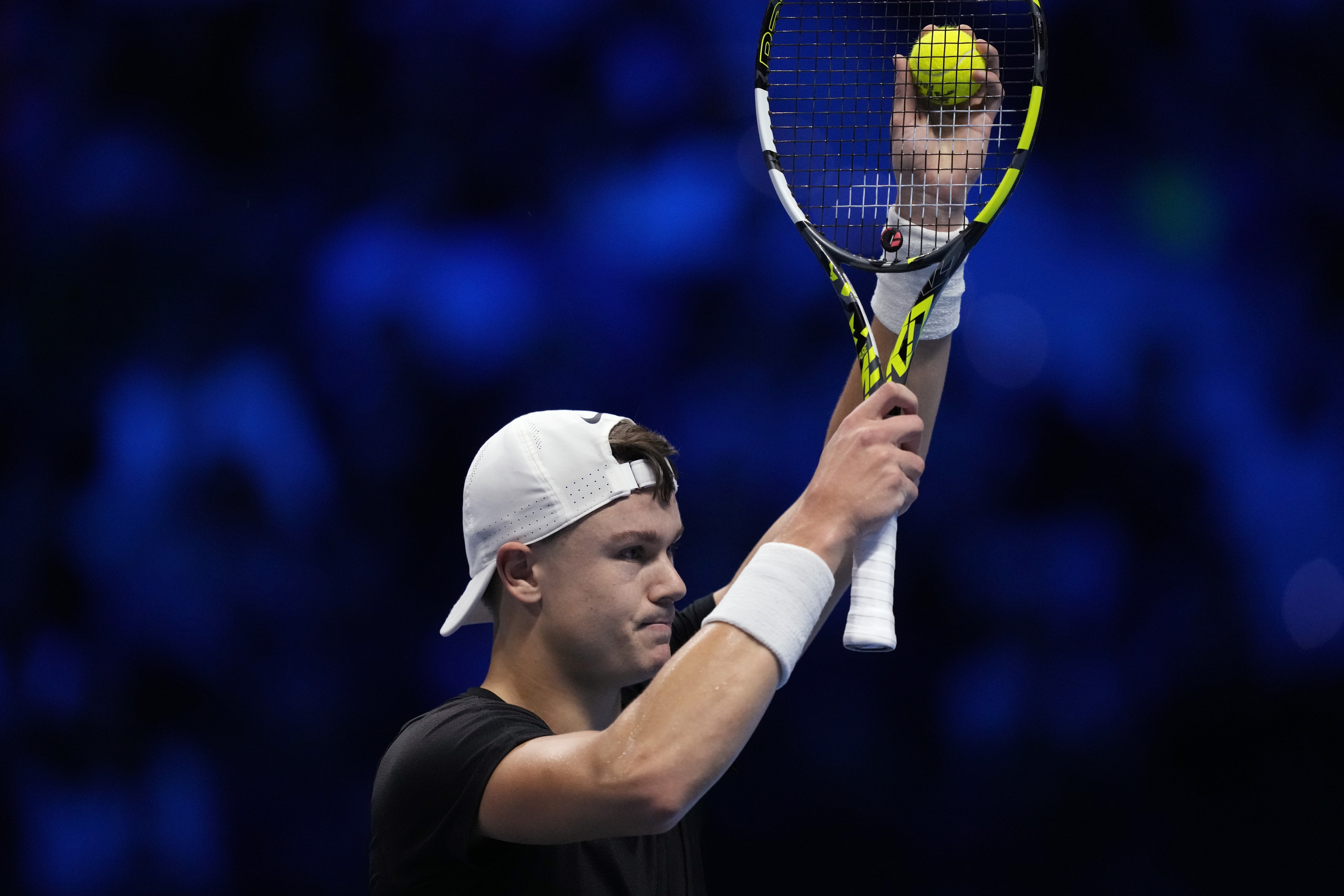 Denmark's Holger Rune reacts during the singles tennis match against Italy's Jannik Sinner, of the ATP World Tour Finals at the Pala Alpitour, in Turin, Italy, Thursday, Nov. 16, 2023. (AP Photo/Antonio Calanni)