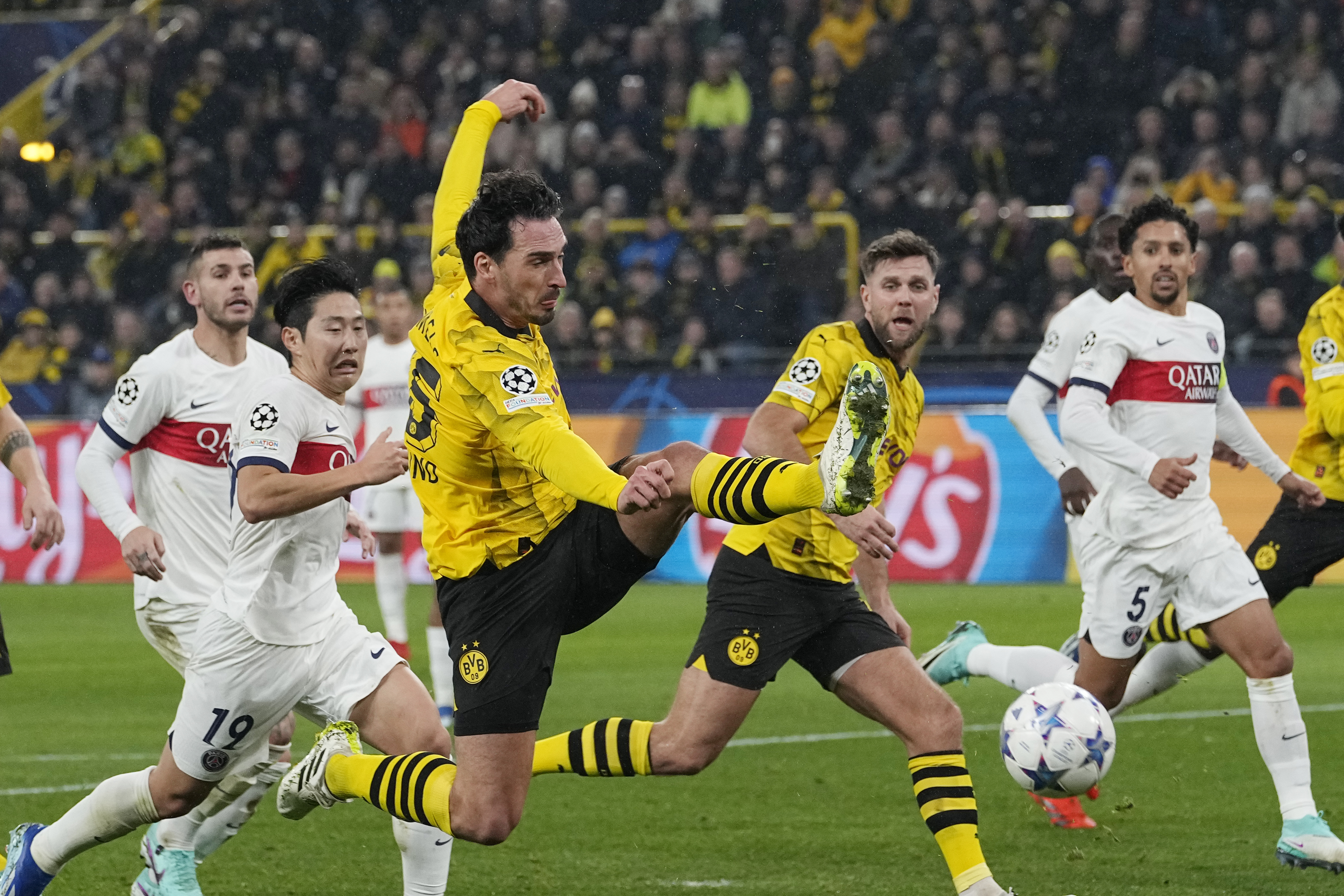 Dortmund's Mats Hummels, centre, misses to score during the Champions League Group F soccer match between Borussia Dortmund and Paris Saint-Germain at the Signal Iduna Park in Dortmund, Germany, Wednesday, Dec. 13, 2023. (AP Photo/Martin Meissner)