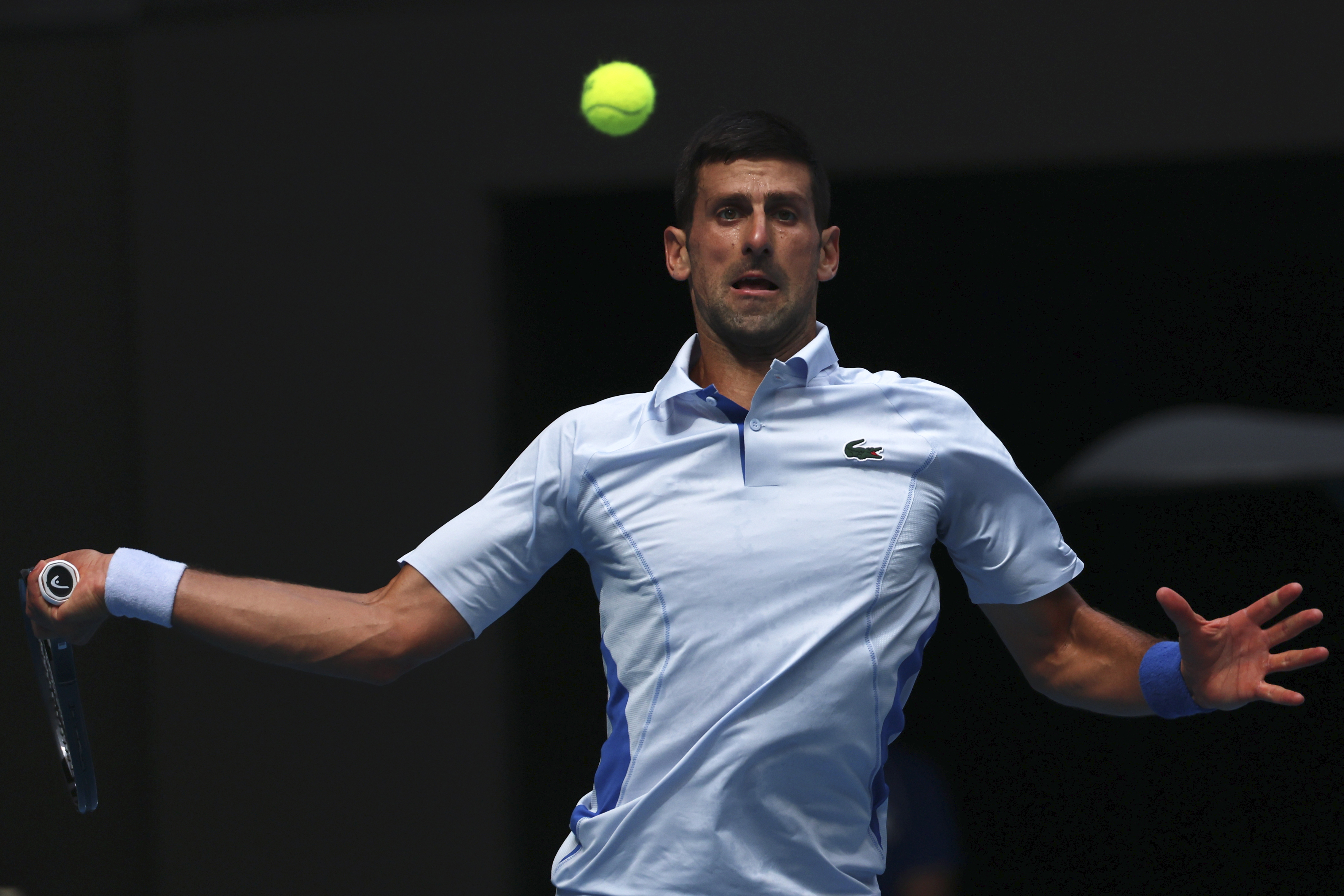 Novak Djokovic of Serbia plays a forehand return to Jannik Sinner of Italy during their semifinal at the Australian Open tennis championships at Melbourne Park, Melbourne, Australia, Friday, Jan. 26, 2024. (AP Photo/Asanka Brendon Ratnayake)