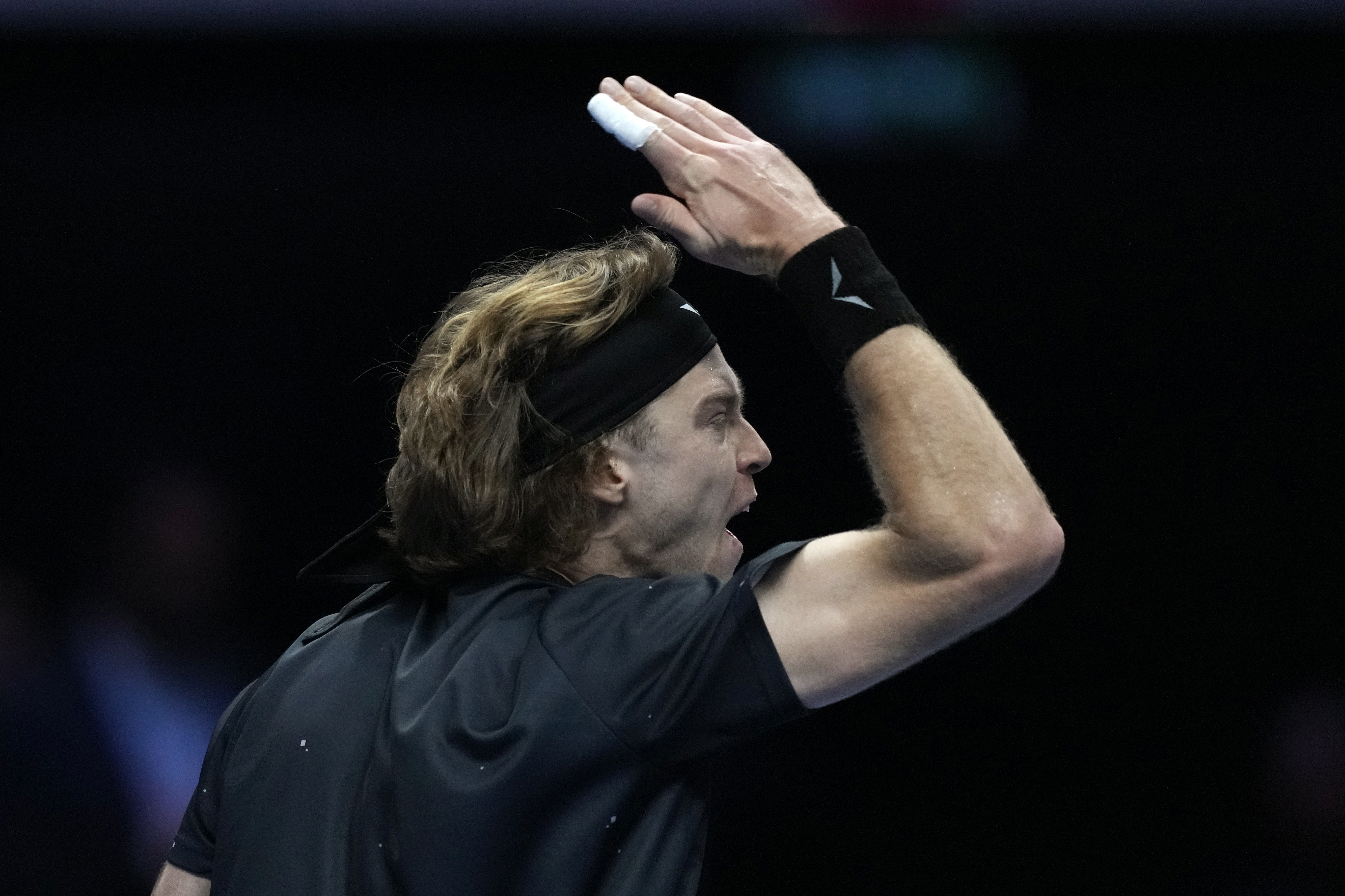 Russia's Andrej Rublev reacts during the singles tennis match against Spain's Carlos Alcaraz, of the ATP World Tour Finals at the Pala Alpitour, in Turin, Italy, Wednesday, Nov. 15, 2023. (AP Photo/Antonio Calanni)