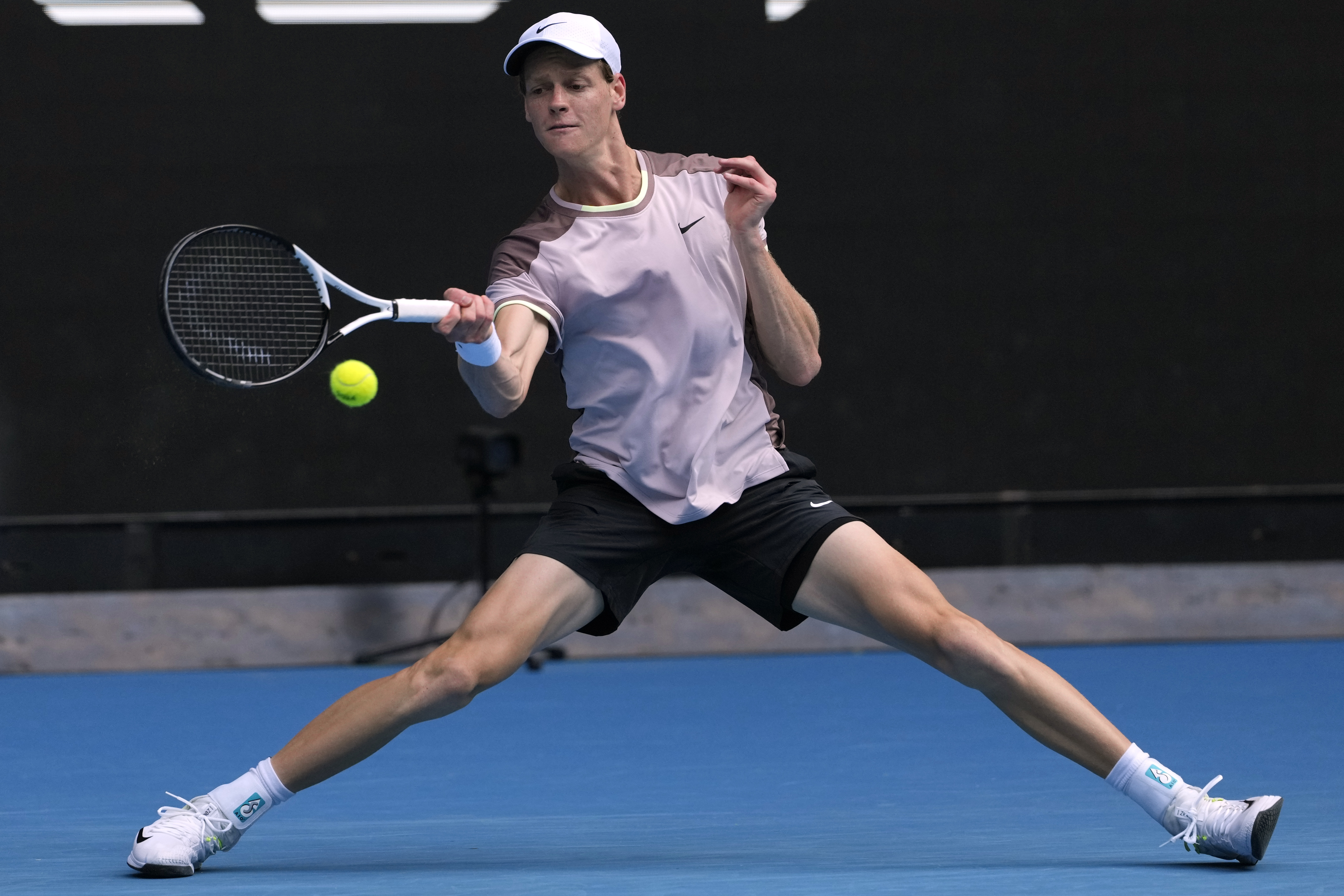Jannik Sinner of Italy plays a forehand return to Karen Khachanov of Russia during their fourth round match at the Australian Open tennis championships at Melbourne Park, Melbourne, Australia, Sunday, Jan. 21, 2024. (AP Photo/Andy Wong)