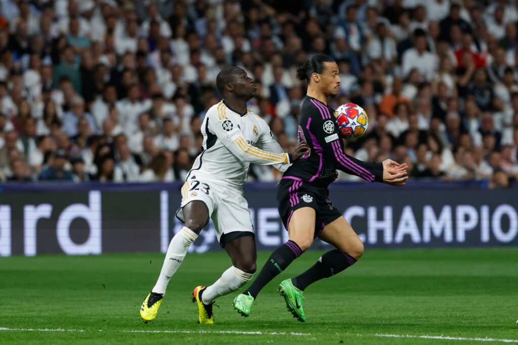 epa11327700 Real Madrid's Ferland Mendy (L) in action against Munich's Leroy Sane during the Champions League semifinal second leg soccer match between Real Madrid and Bayern Munich, in Madrid, Spain, 08 May 2024.  EPA-EFE/JUANJO MARTIN
