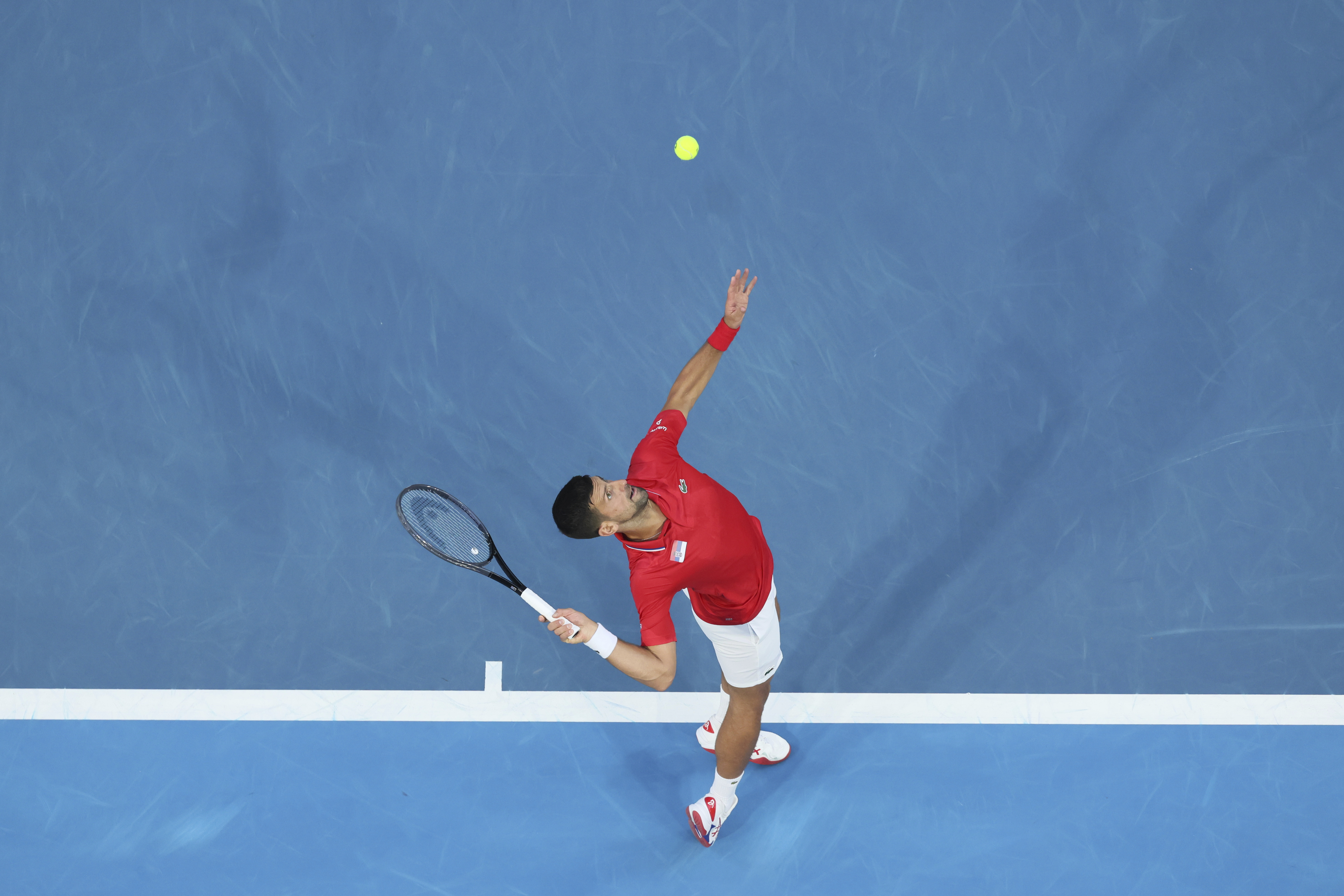 Novak Djokovic of Serbia serves to Zhizhen Zhang of China during the United Cup tennis tournament in Perth, Australia, Sunday, Dec. 31, 2023. (AP Photo/Trevor Collens)